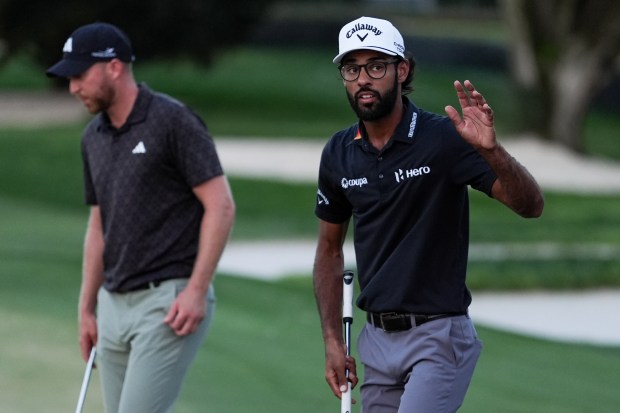 Akshay Bhatia waves to the gallery after sinking a putt on the 15th hole during the third round of the Arnold Palmer Invitational Saturday at Bay Hill Club & Lodge in Orlando. (AP Photo/Matt Slocum)
