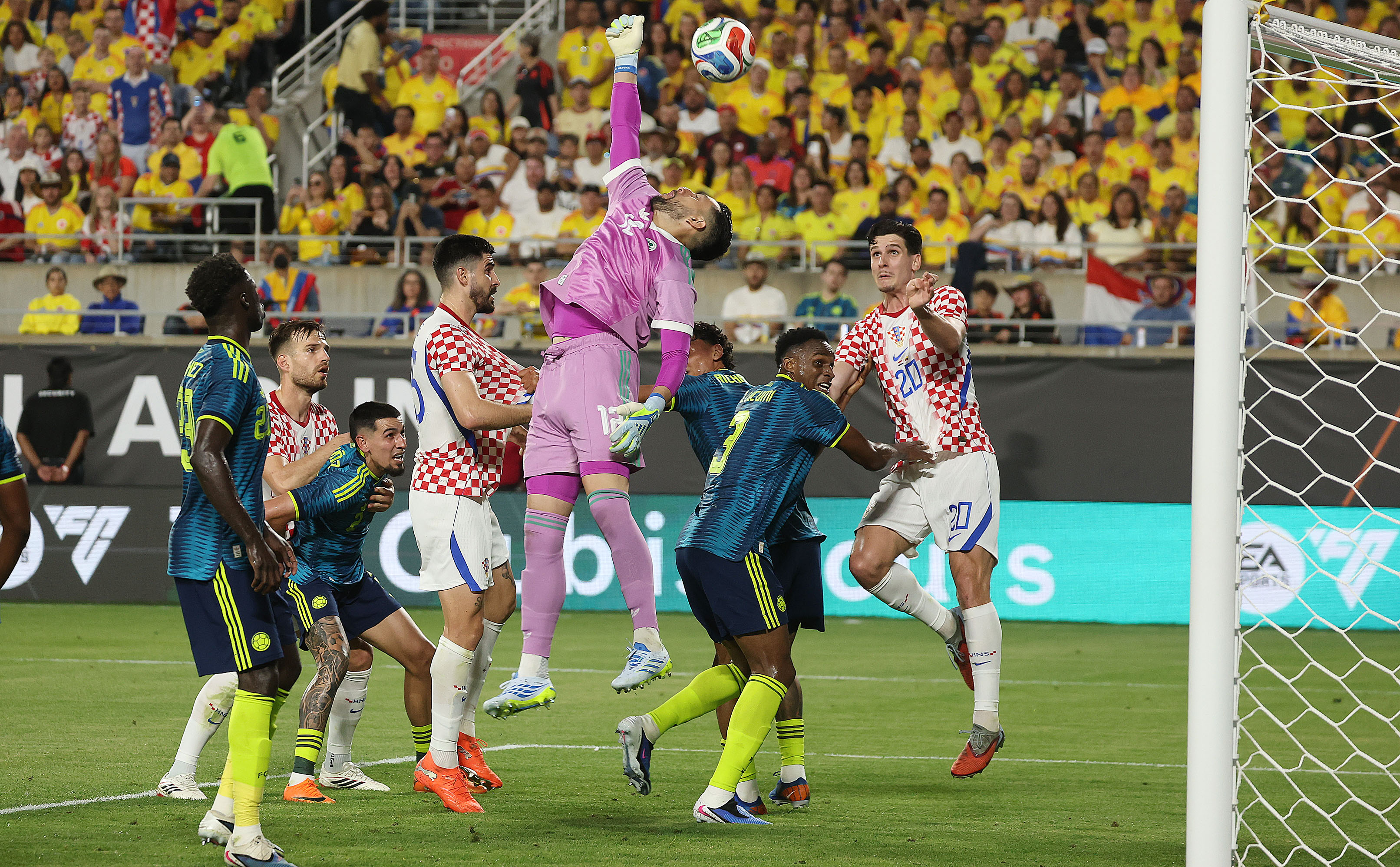 Colombia goalkeeper Camilo Vargas (middle) leaps for the ball during...