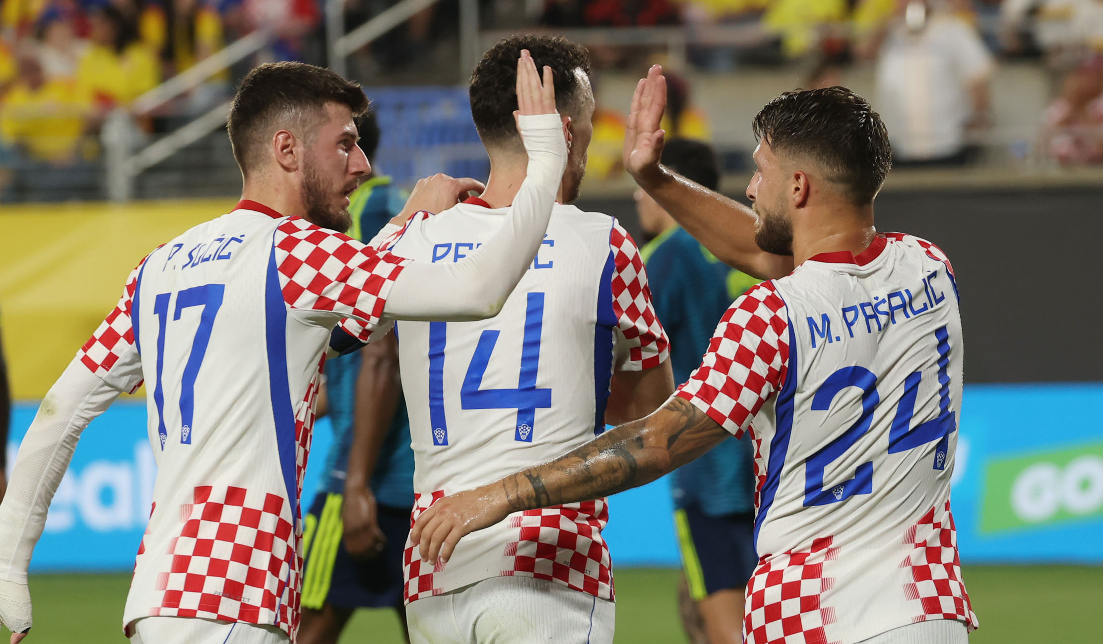 Croatia players Peter Sucic (17), Ivan Perisic (14), and Marco...