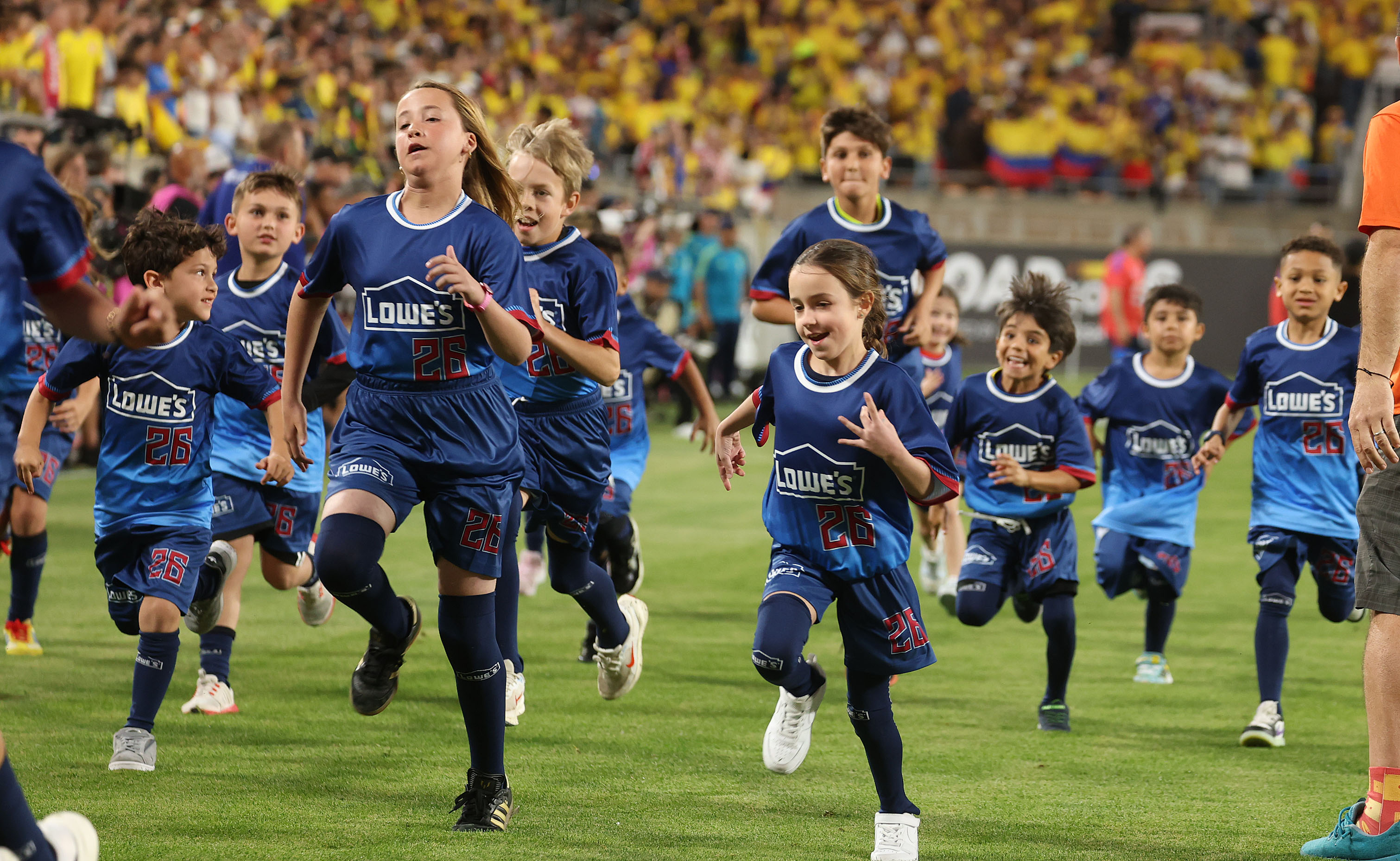 Kids run off the pitch before the Road to 26...