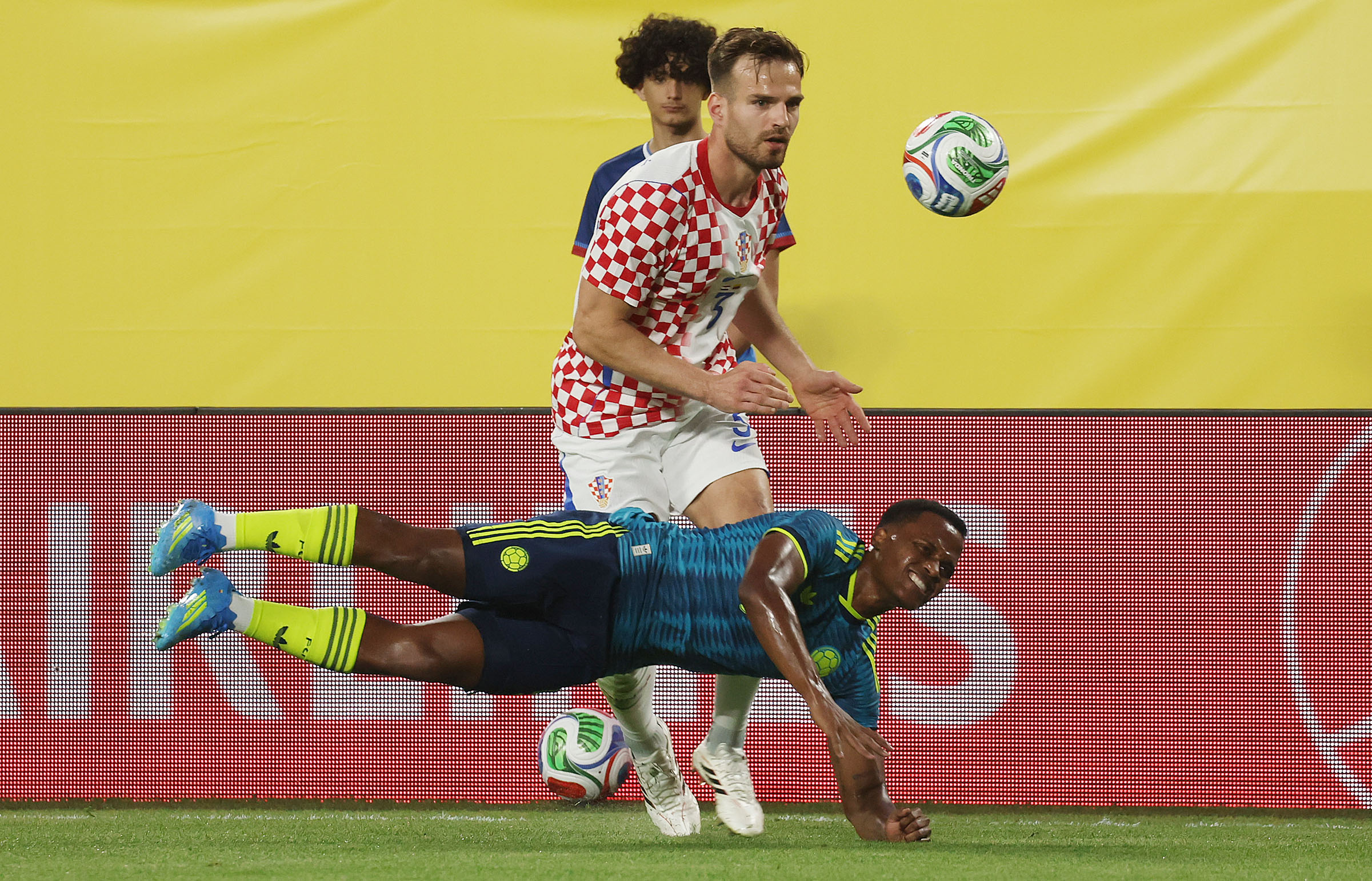 Colombia player Jhon Arias (bottom) dives under Croatia player Marin...