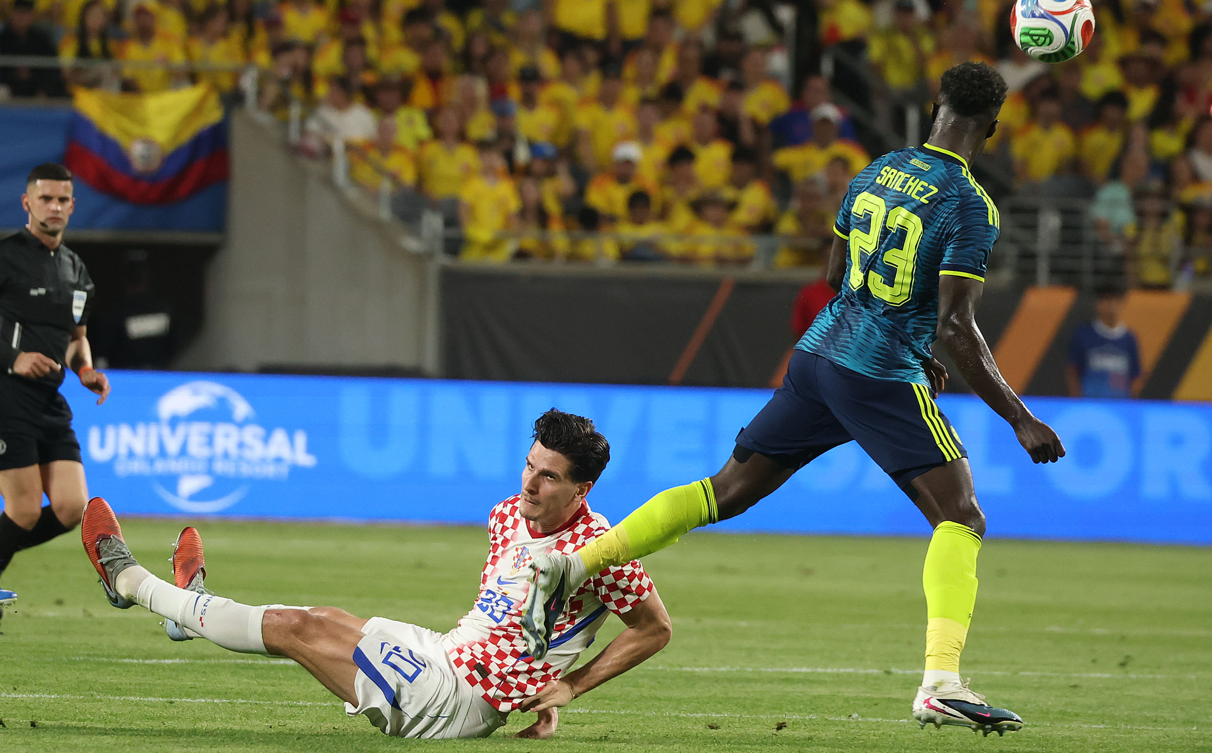Croatia player I Matanovic (bottom) falls under Colombia player D....