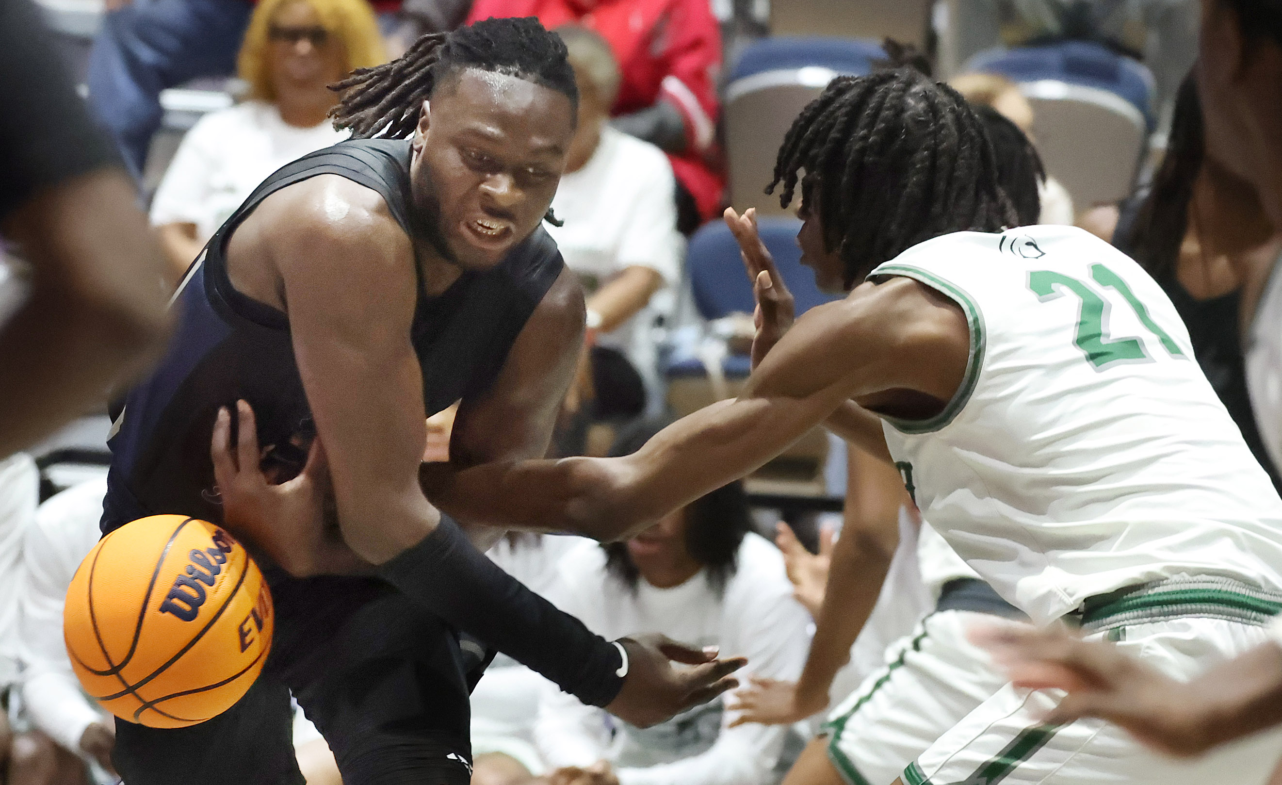 Evans player Dewayne Dizon (21) knocks the ball away from...