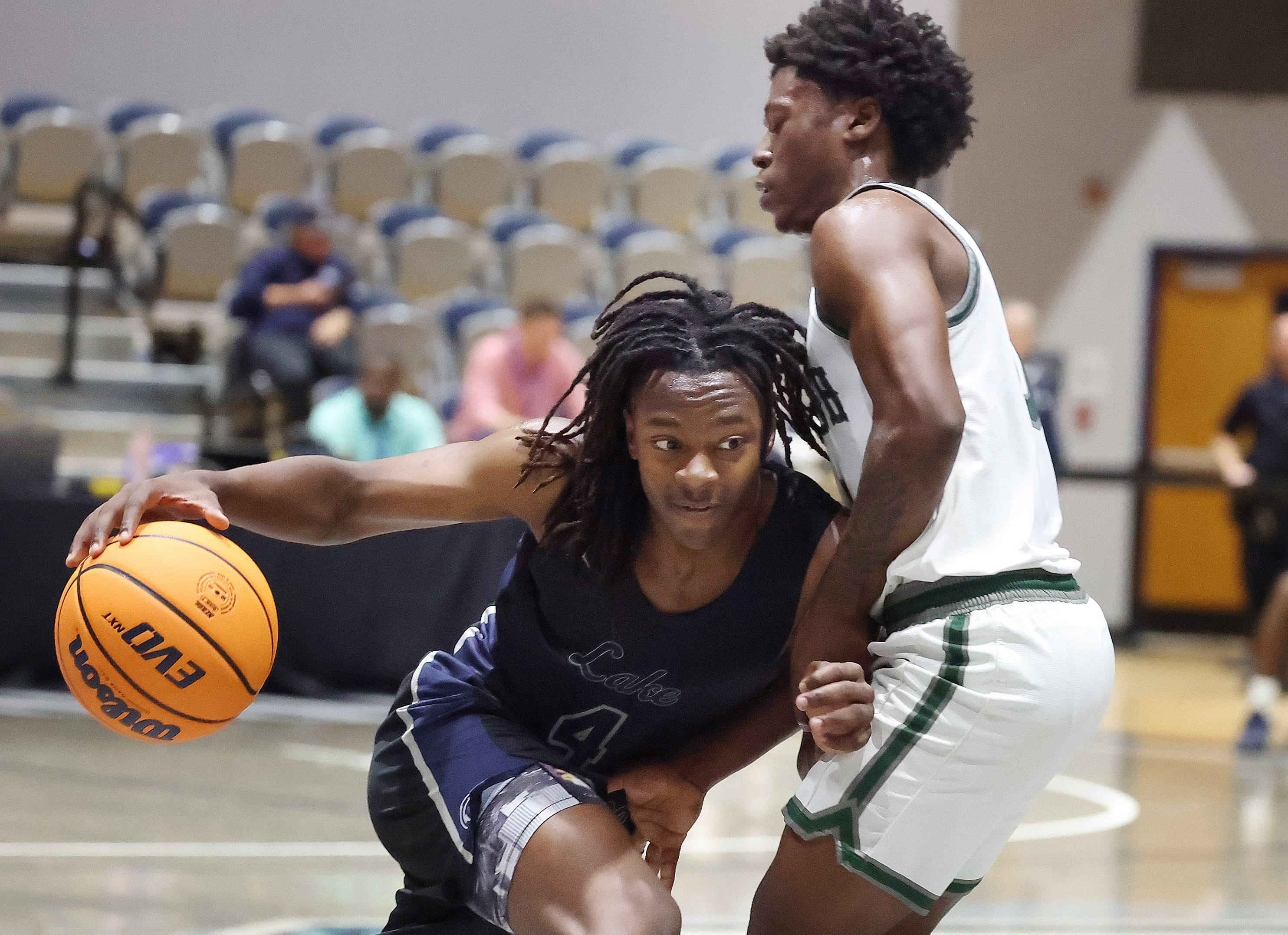 Lake Howell player Johnas Maurice (4) drives through Evans player...