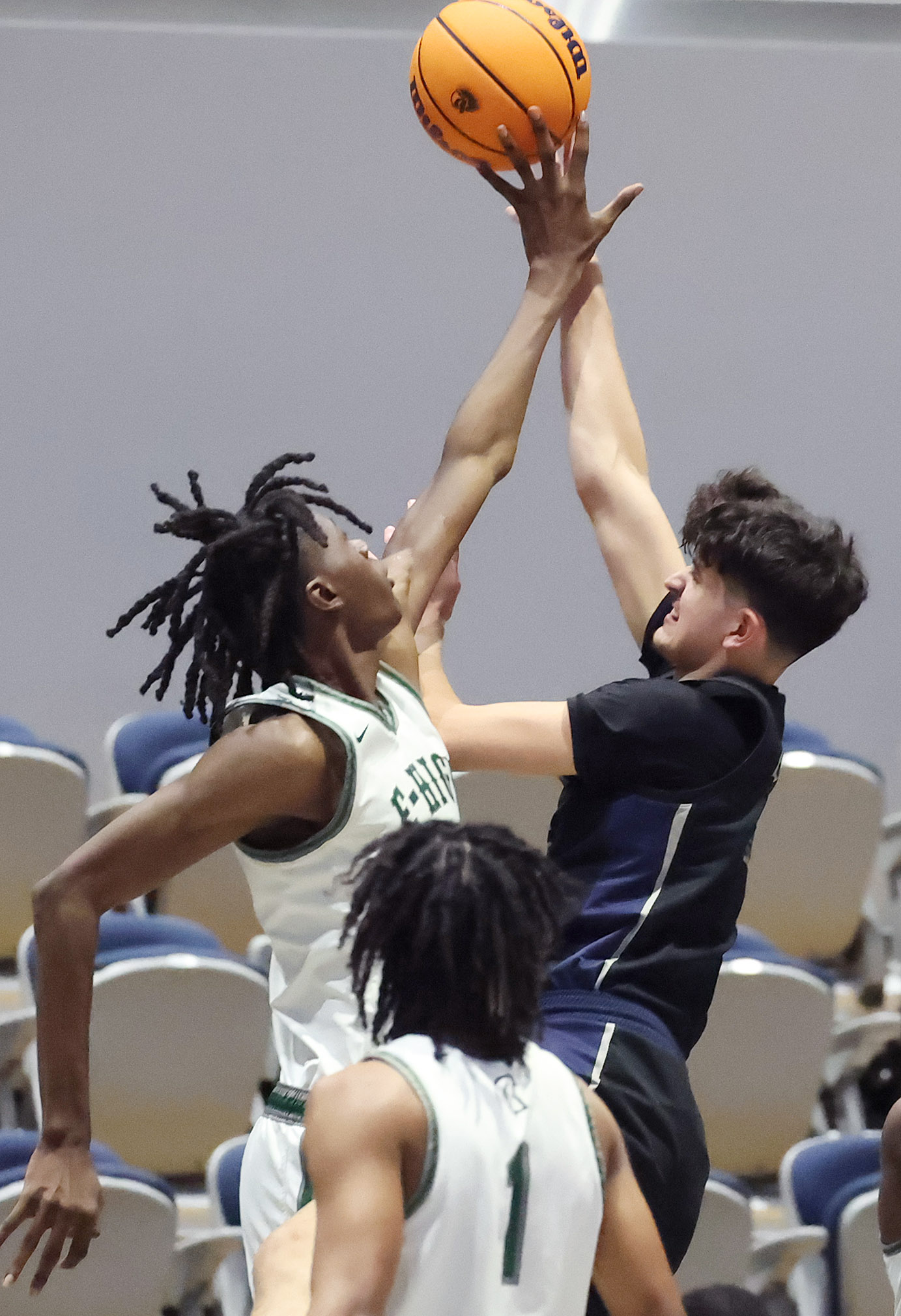 Evans player Dewayne Dixon (left) blocks a shot by Lake...
