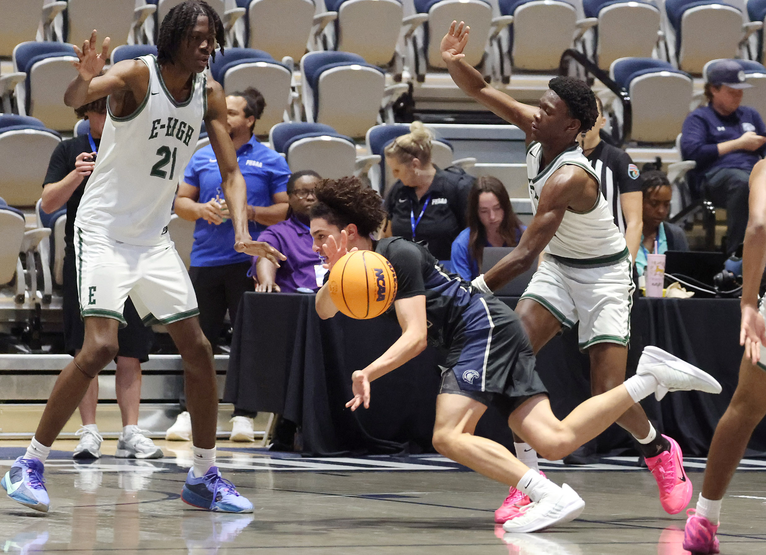 Lake Howell player Sami Atari (middle) falls as he passes...