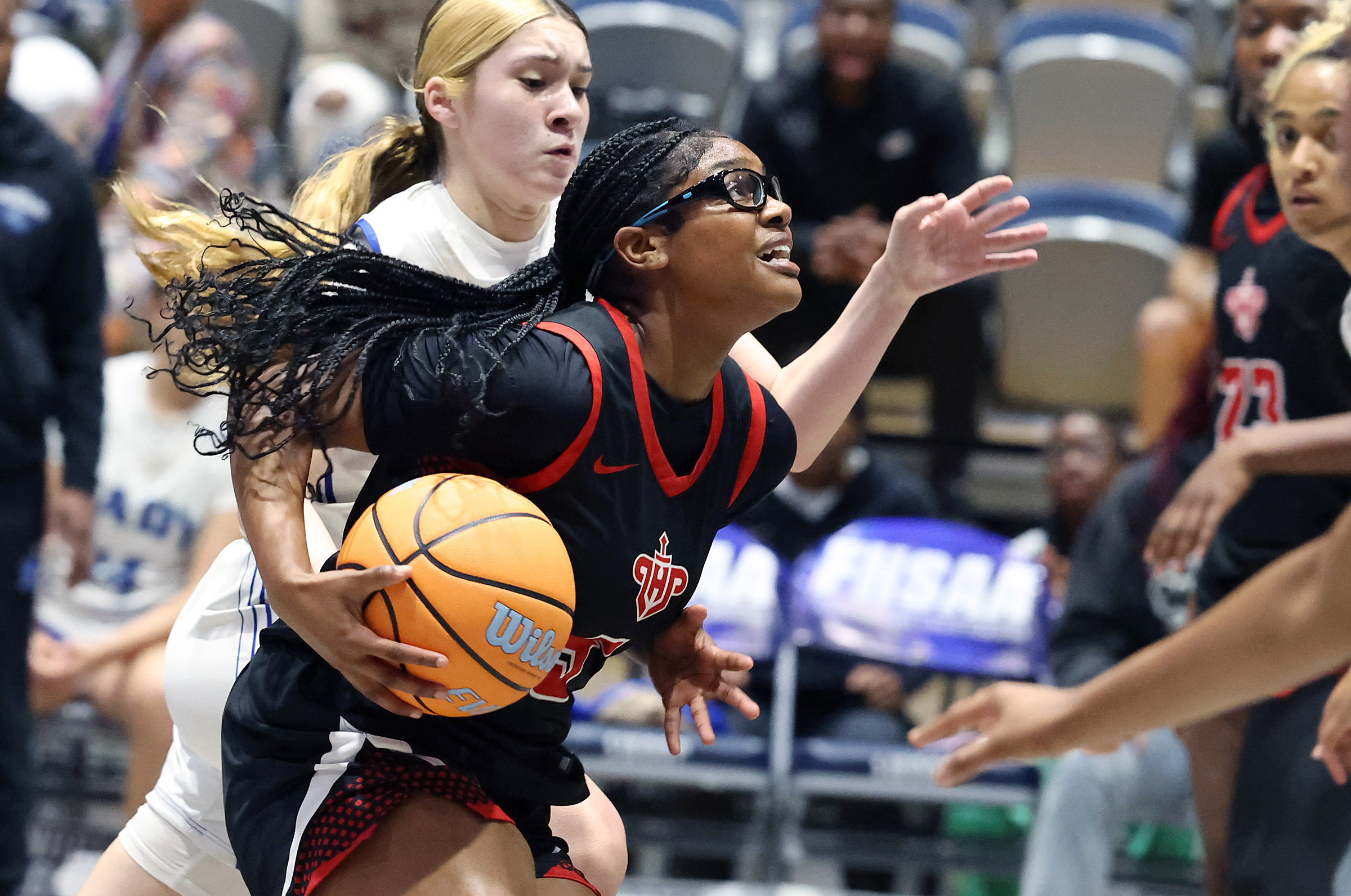Lake Highland player A'Niyah Liptrot (5) drives the lane during...