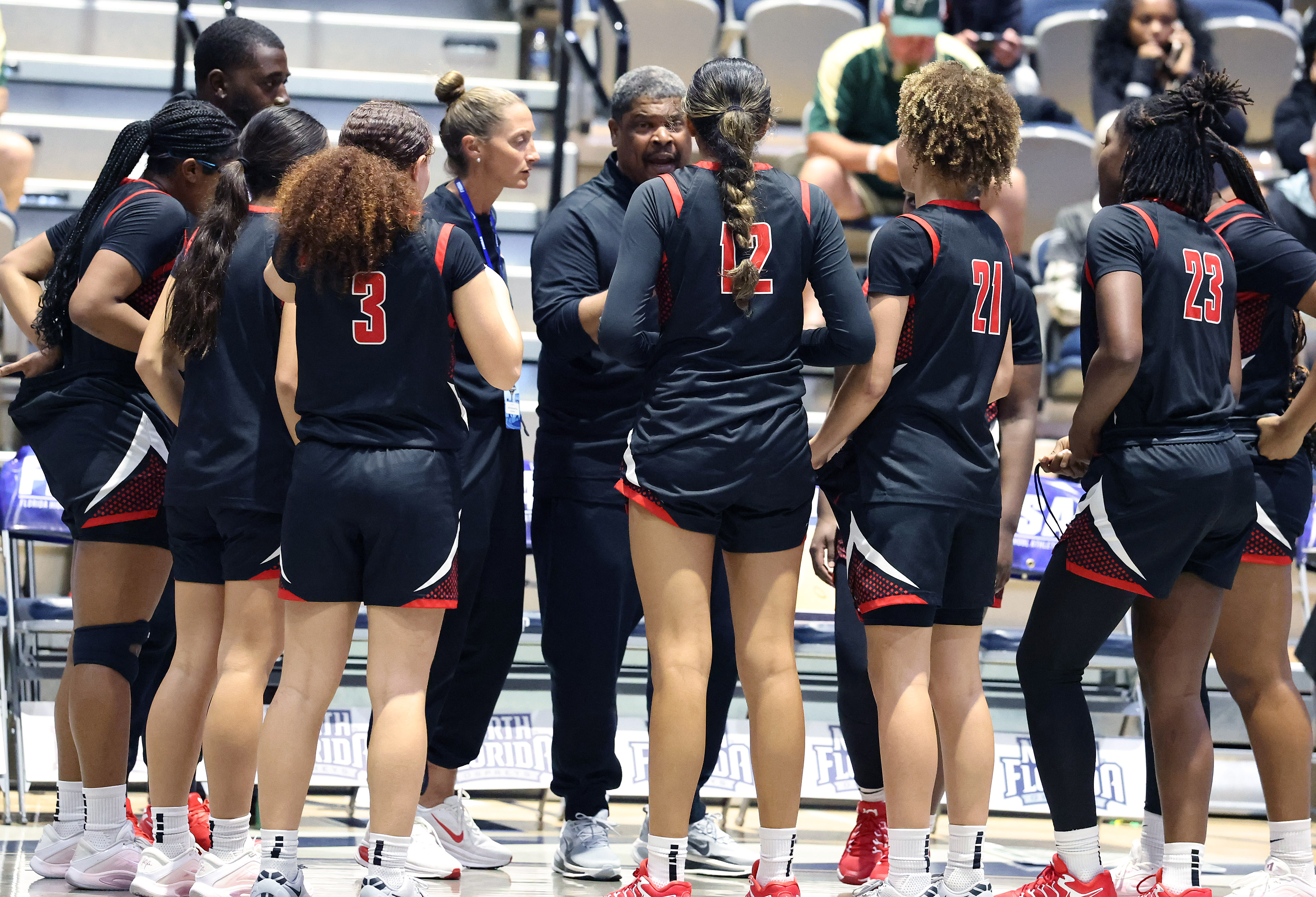 Lake Highland players gather during the FHSAA Girls Basketball 3A...
