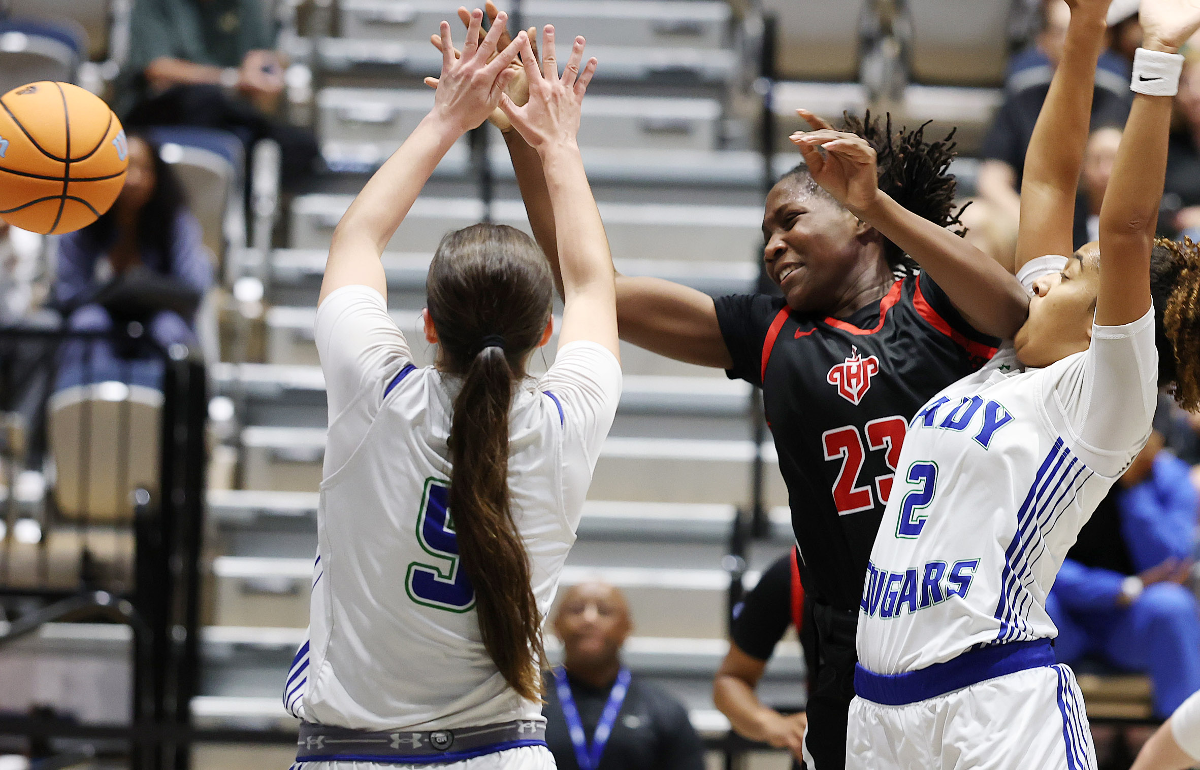 Lake Highland player Saleigh Simpson (23) passes among defenders during...