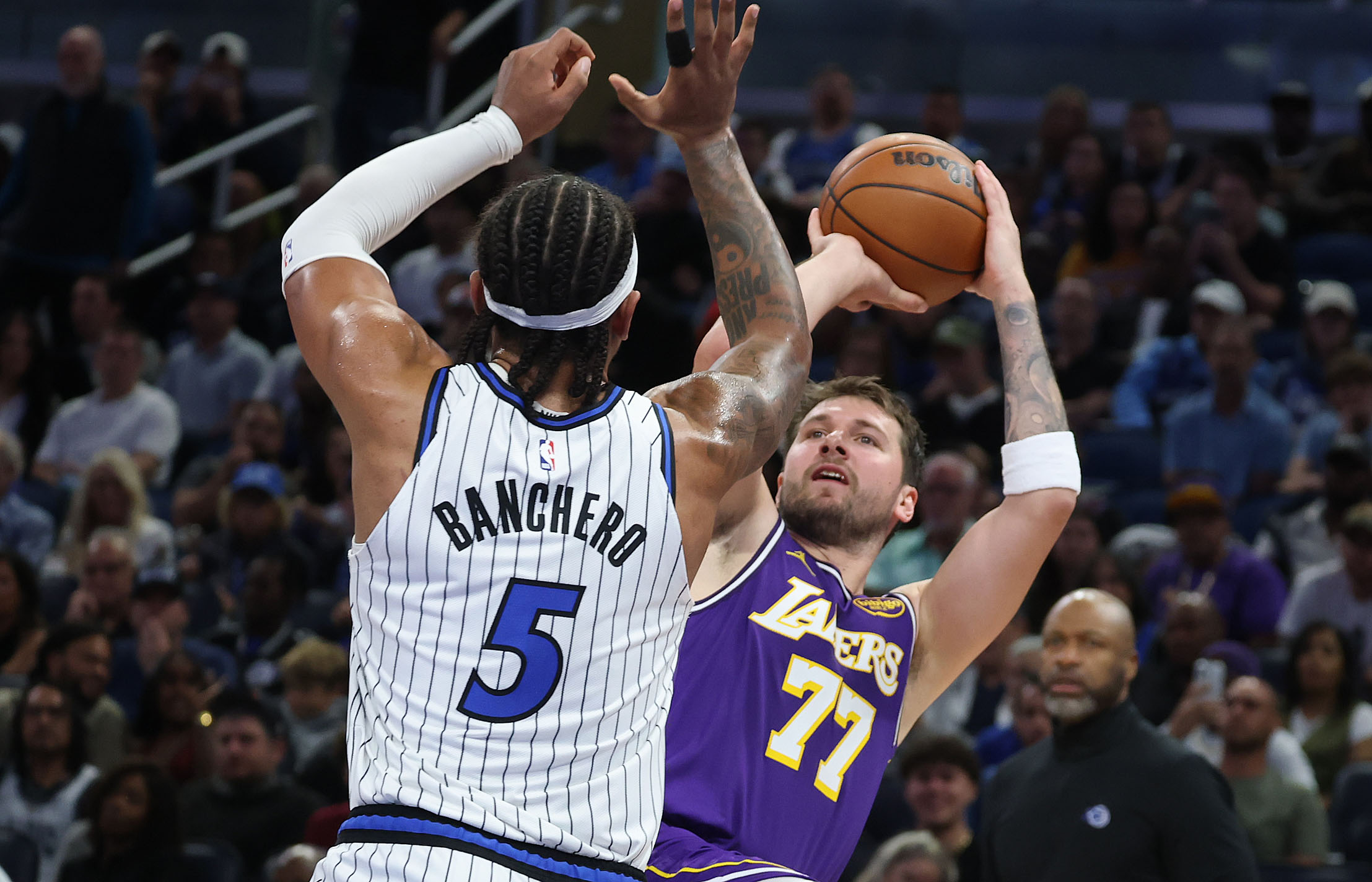 LA guard Luka Doncic (77) shoots under Orlando forward Paolo...