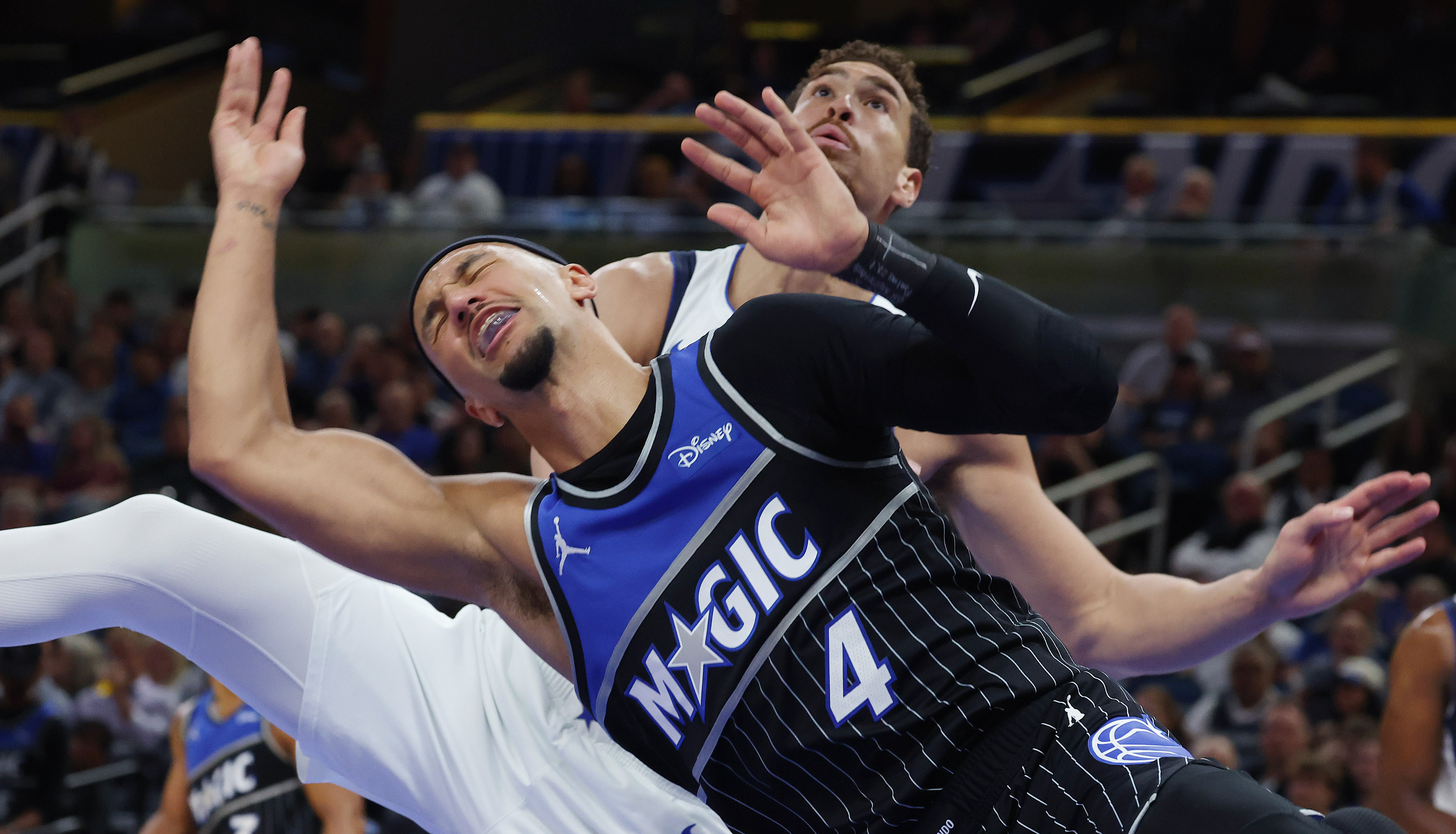 Orlando guard Jalen Suggs (4) is fouled by Dallas center...