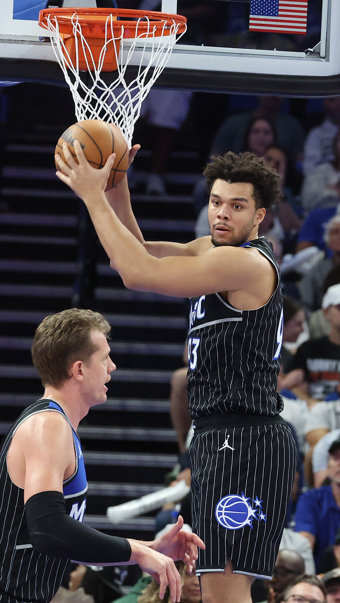 Orlando forward Noah Penda (top) pulls down a rebound over...