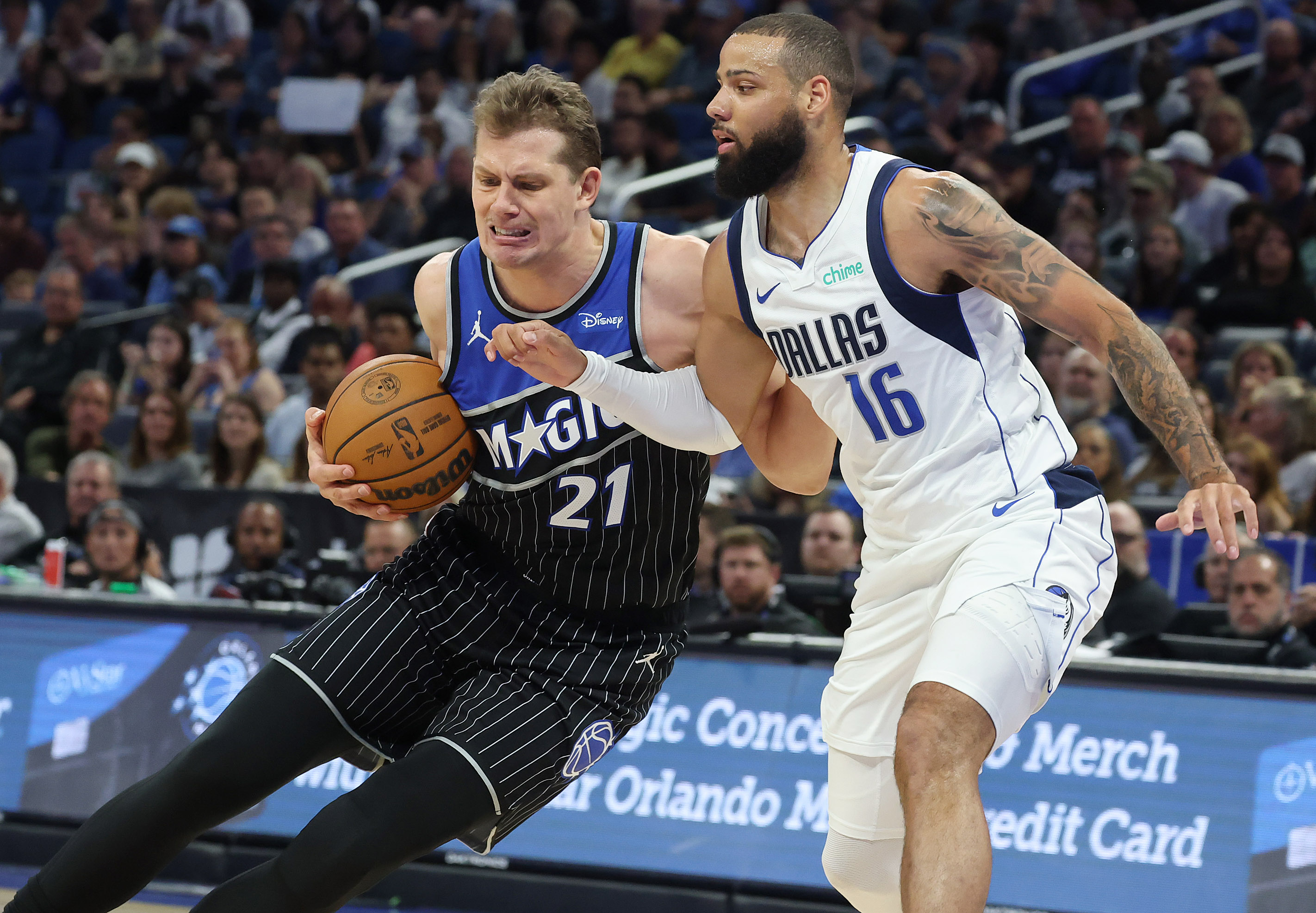 Orlando center Mo Wagner (21) drives around Dallas forward Caleb...