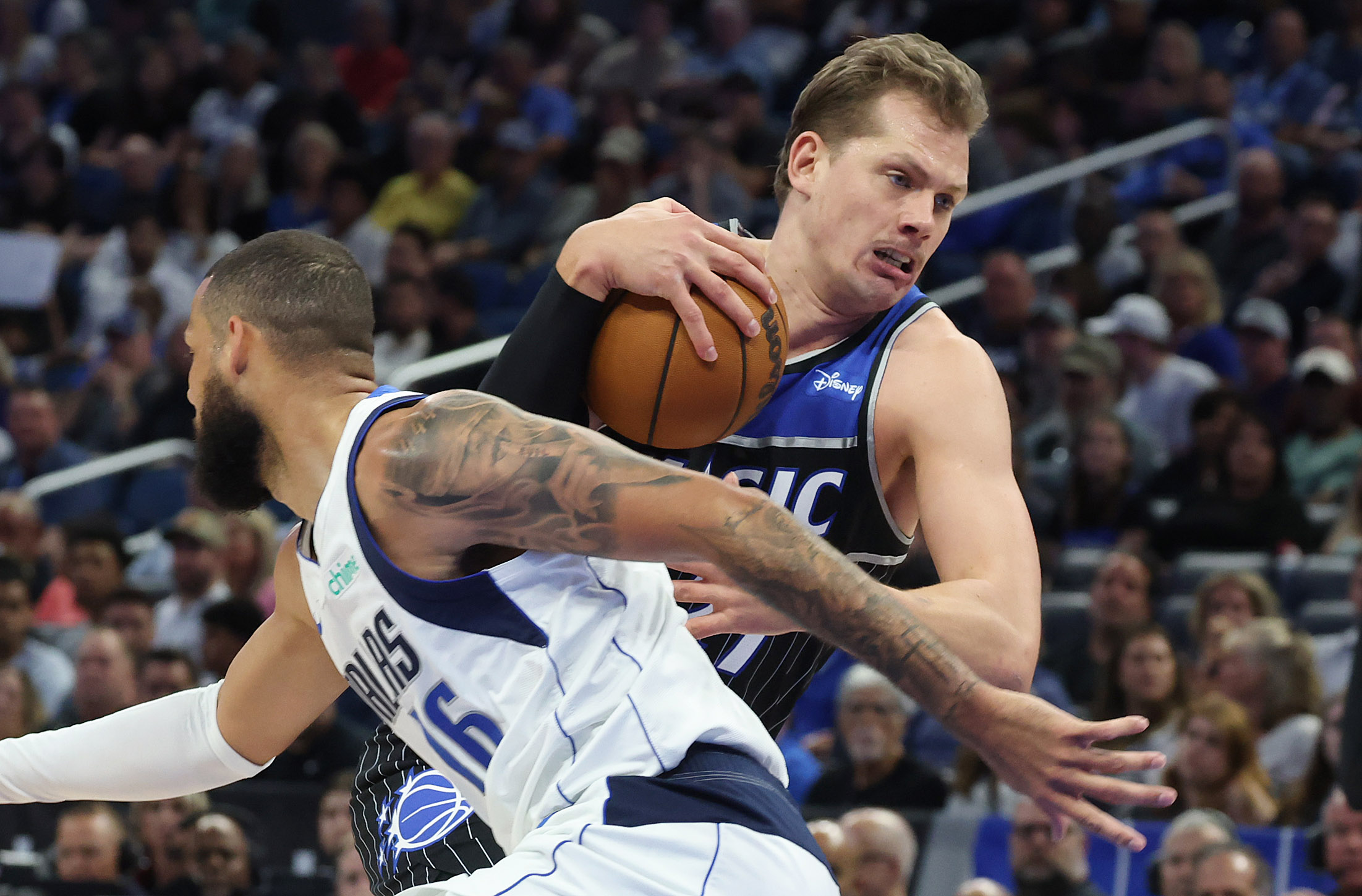 Orlando center Mo Wagner (right) shoves aside Dallas forward Caleb...
