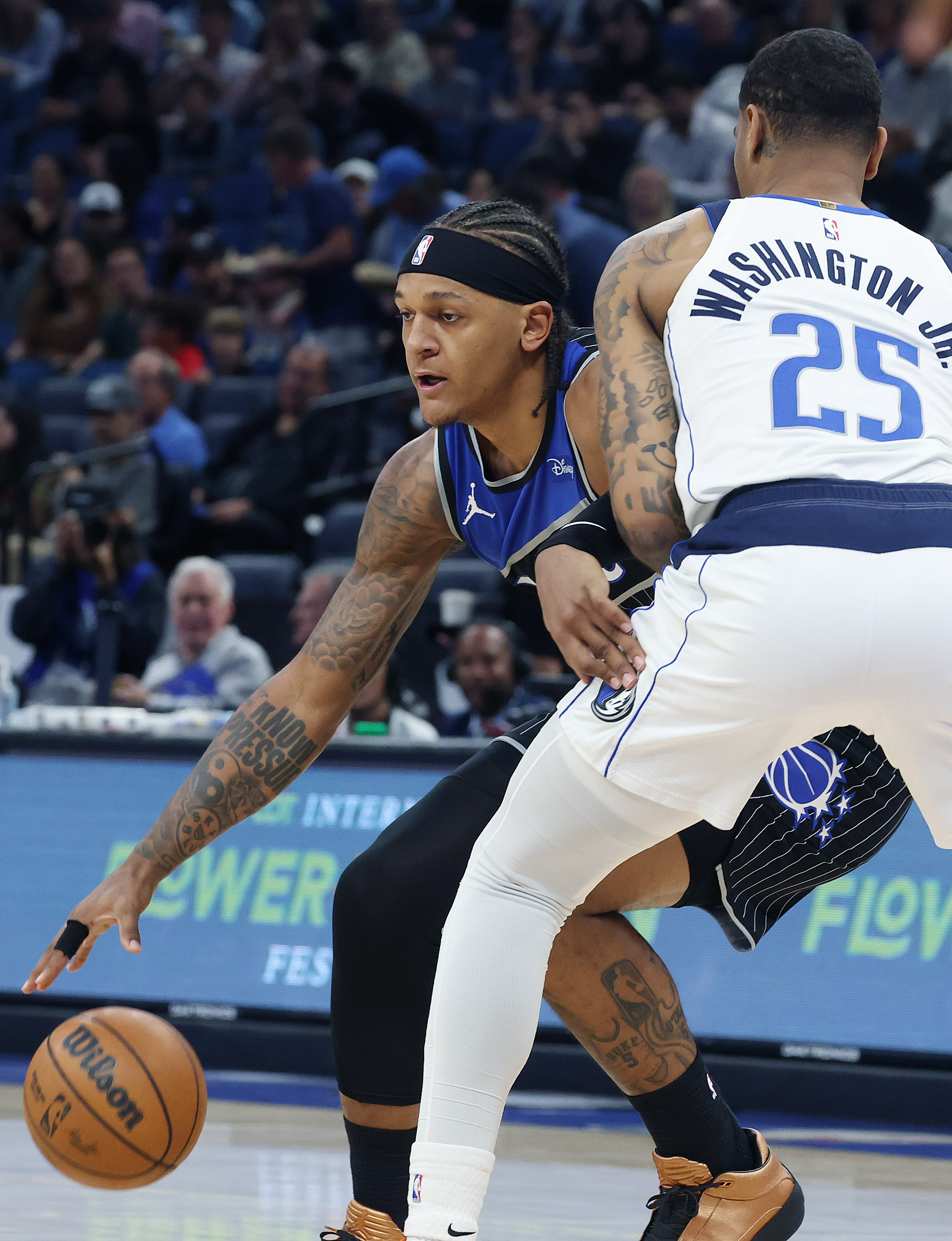 Orlando forward Paolo Banchero (left) pushes past Dallas forward P.J....