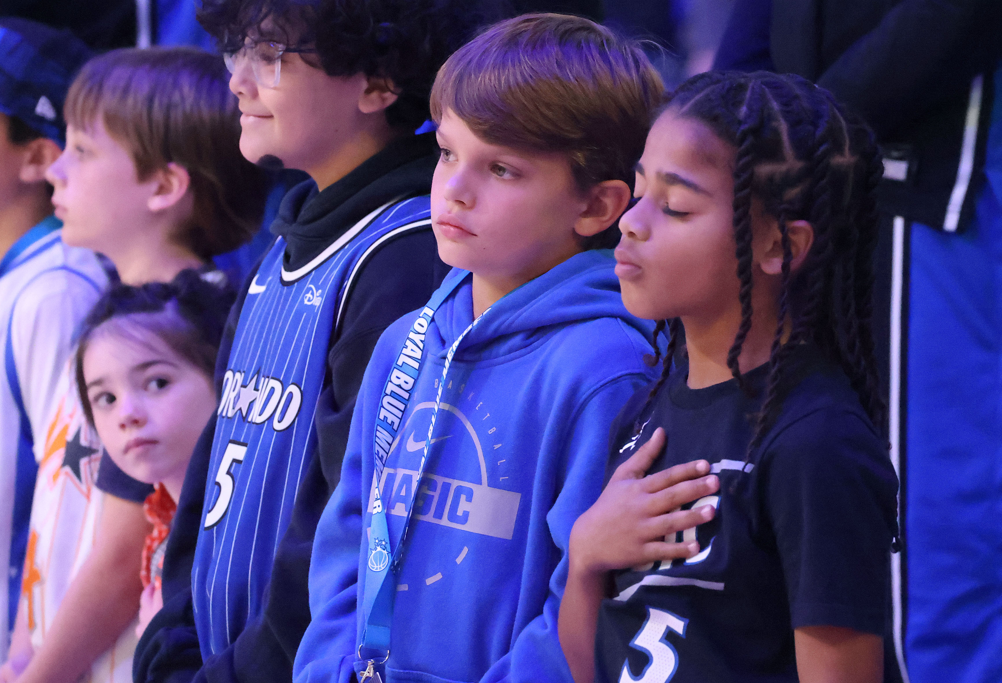 Young fans are pictured during the national anthem before the...