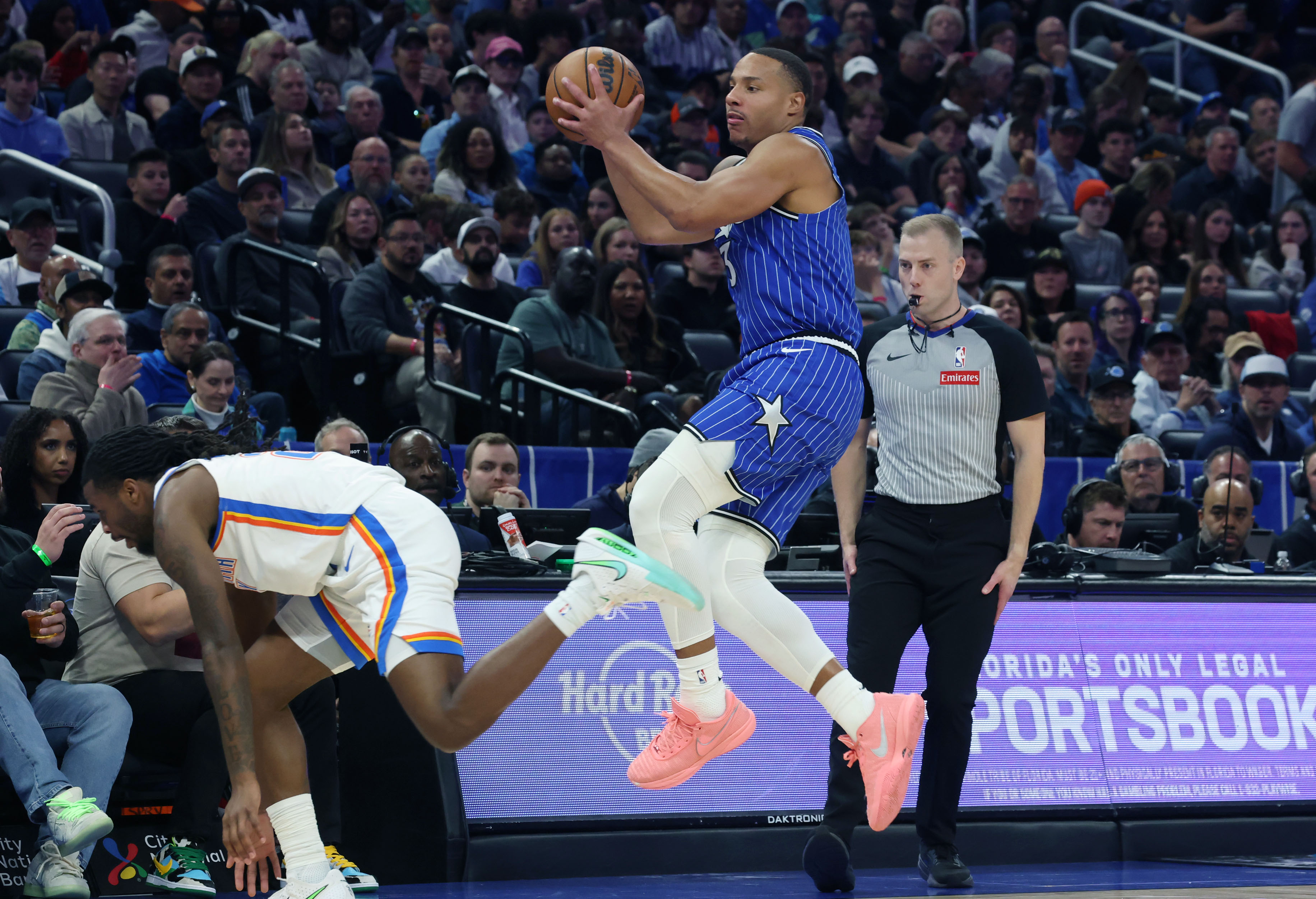 Magic guard Desmond Bane leaps for a pass during the...