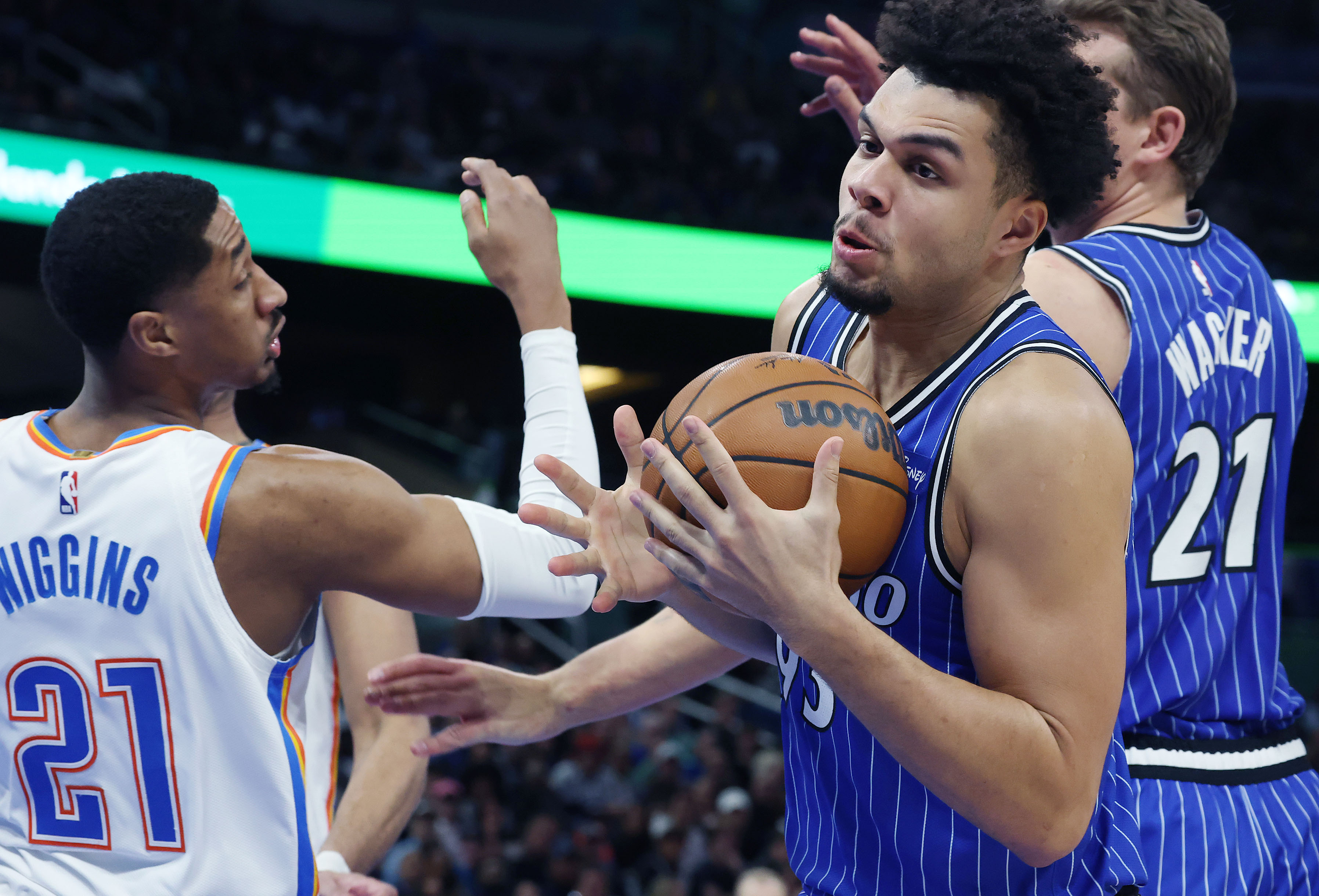 Magic forward Noah Penda (93) grabs a rebound beside Thunder...