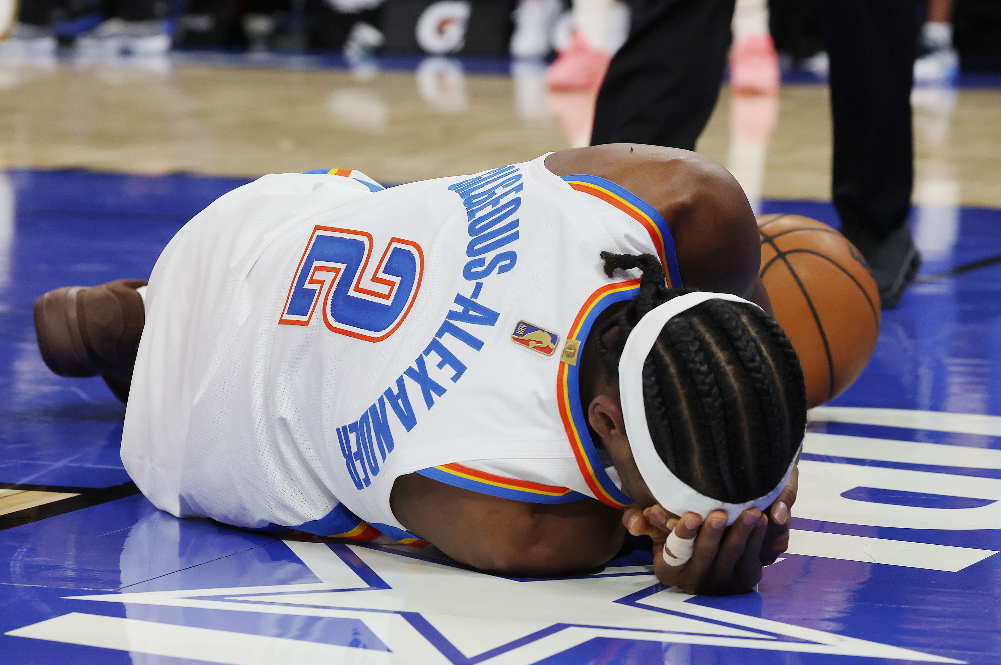 Thunder guard Shai Gilgeous-Alexander (2) lies on the floor after...