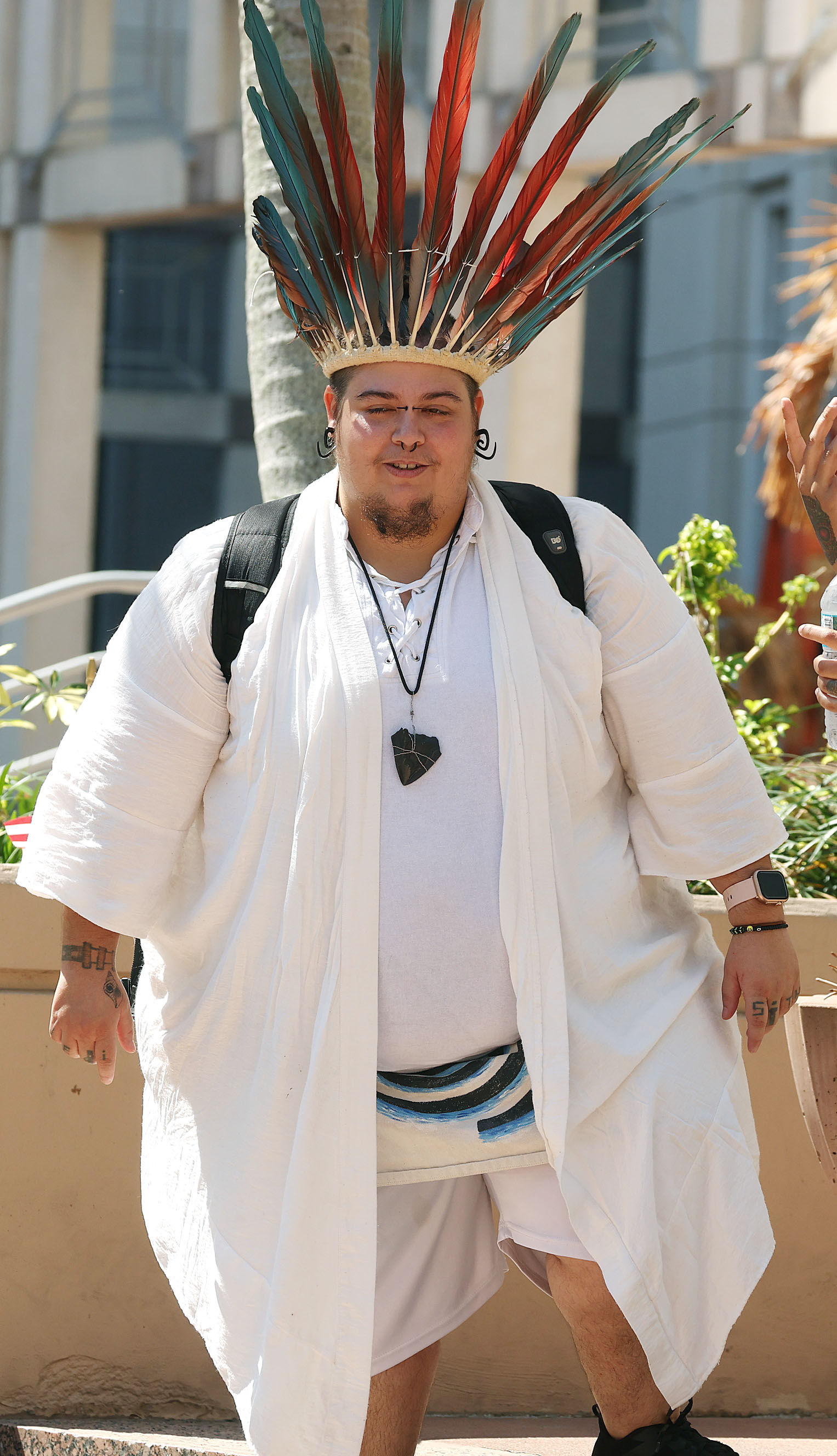 A protestor wears an outfit as he joins thousands in...