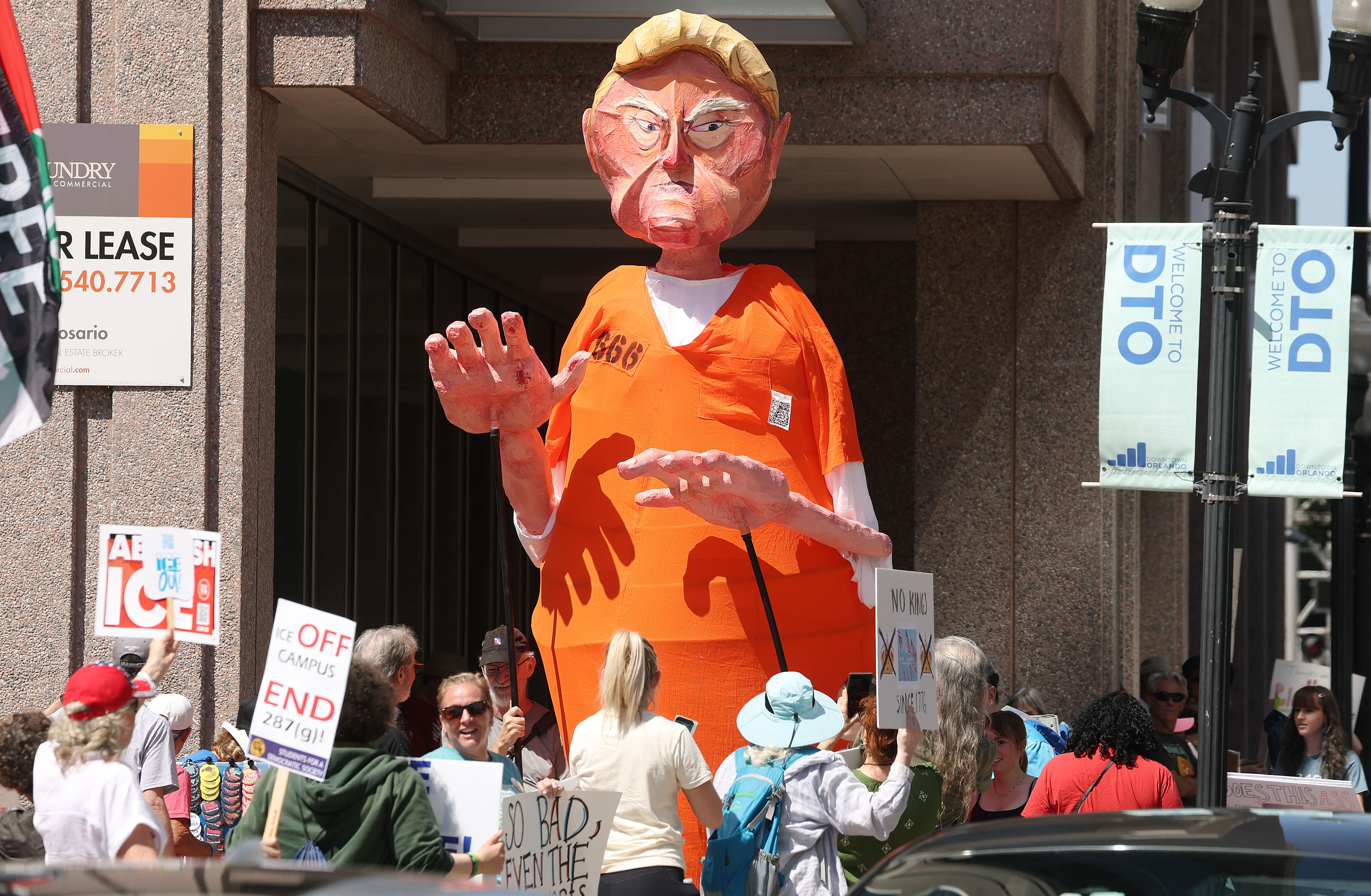 Protestors display a large Trump figure as they join thousands...