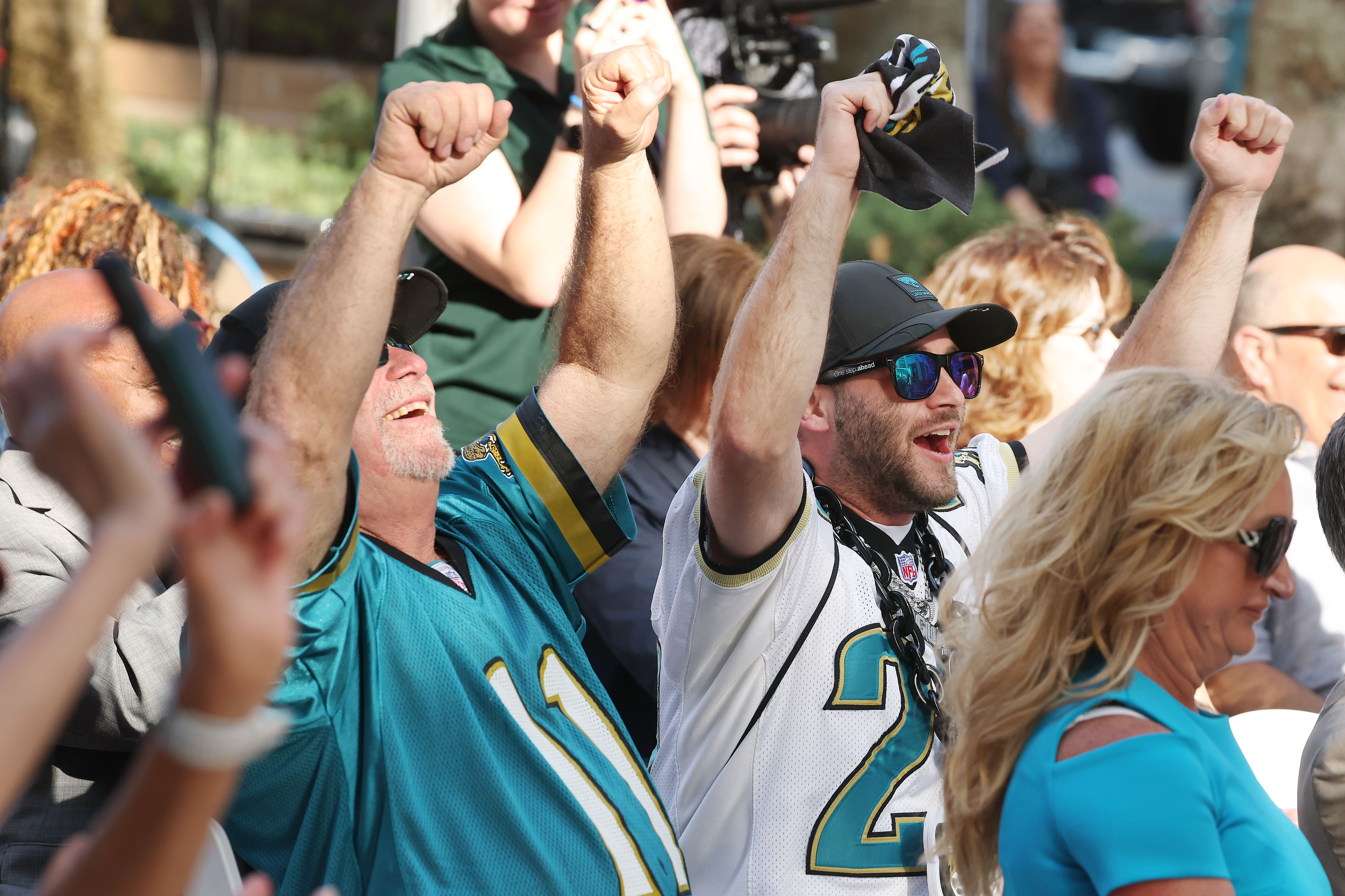 Longtime Jacksonville Jaguars fans Bill Briggs (center left) and Nick...