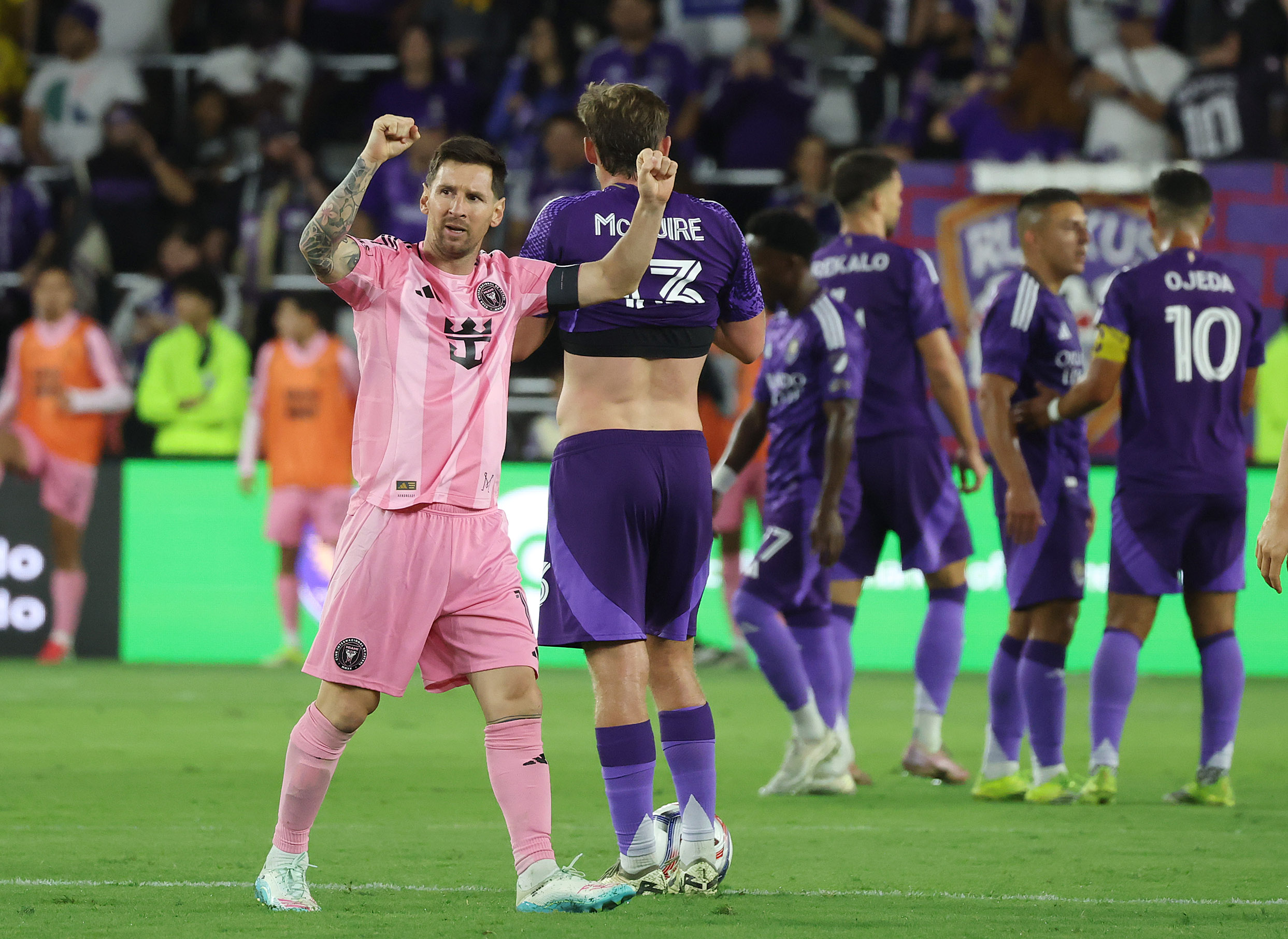 Miami player Lionel Messi celebrates in front of Orlando players...