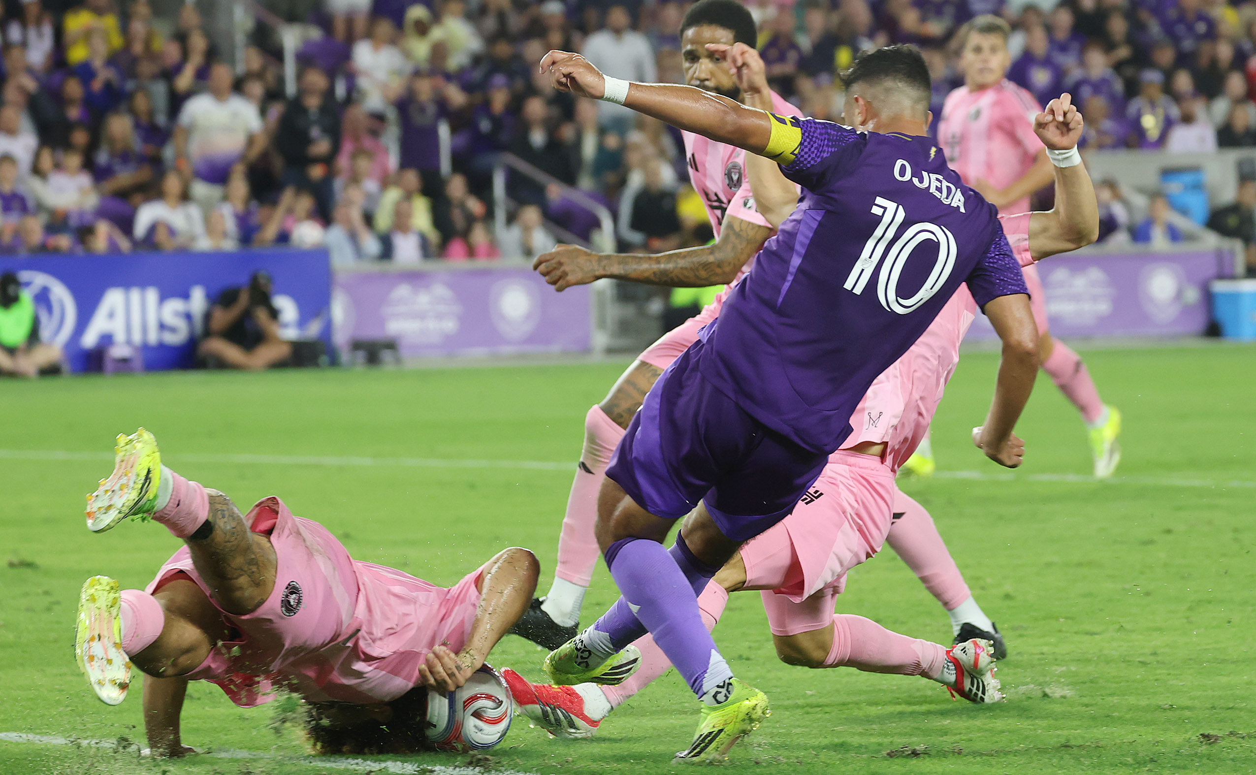 Miami player Maximiliano Falcon (left) falls down to make a...