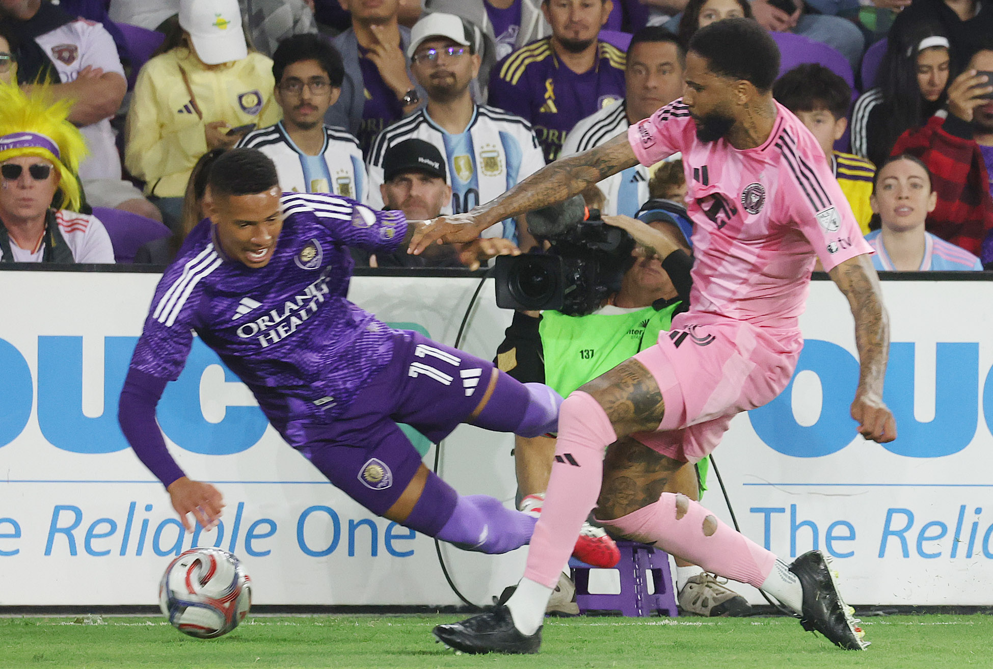 Miami player Micael (right) and Orlando player Tiago (11) collide...