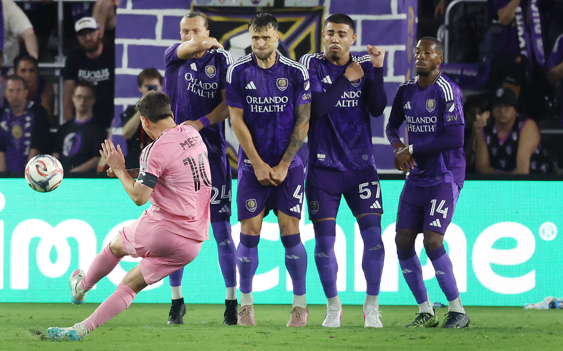 Miami player Lionel Messi scores a goal past Orlando players...