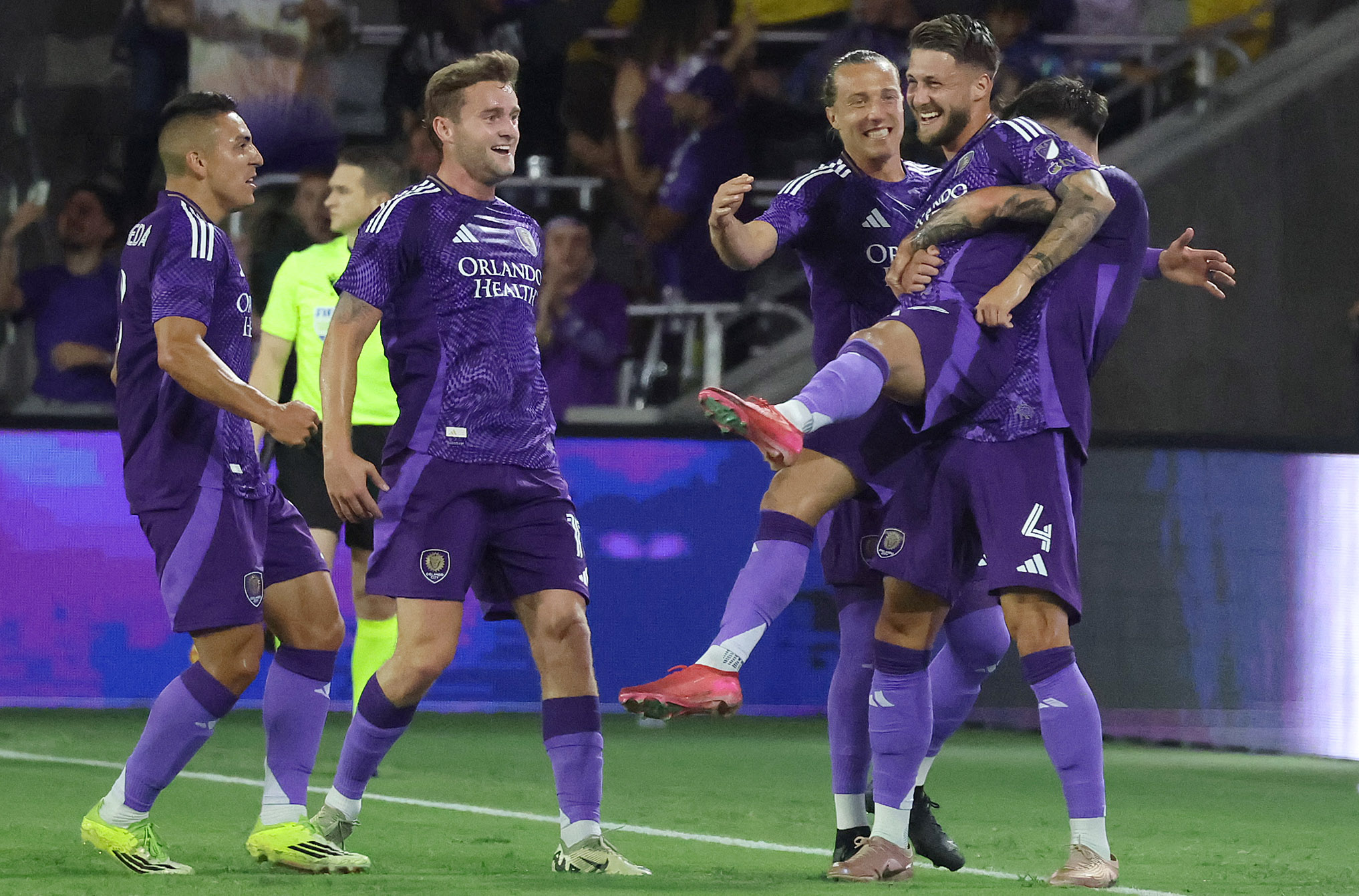 Orlando player Marco Pasalic (being lifted) celebrates with teammates after...