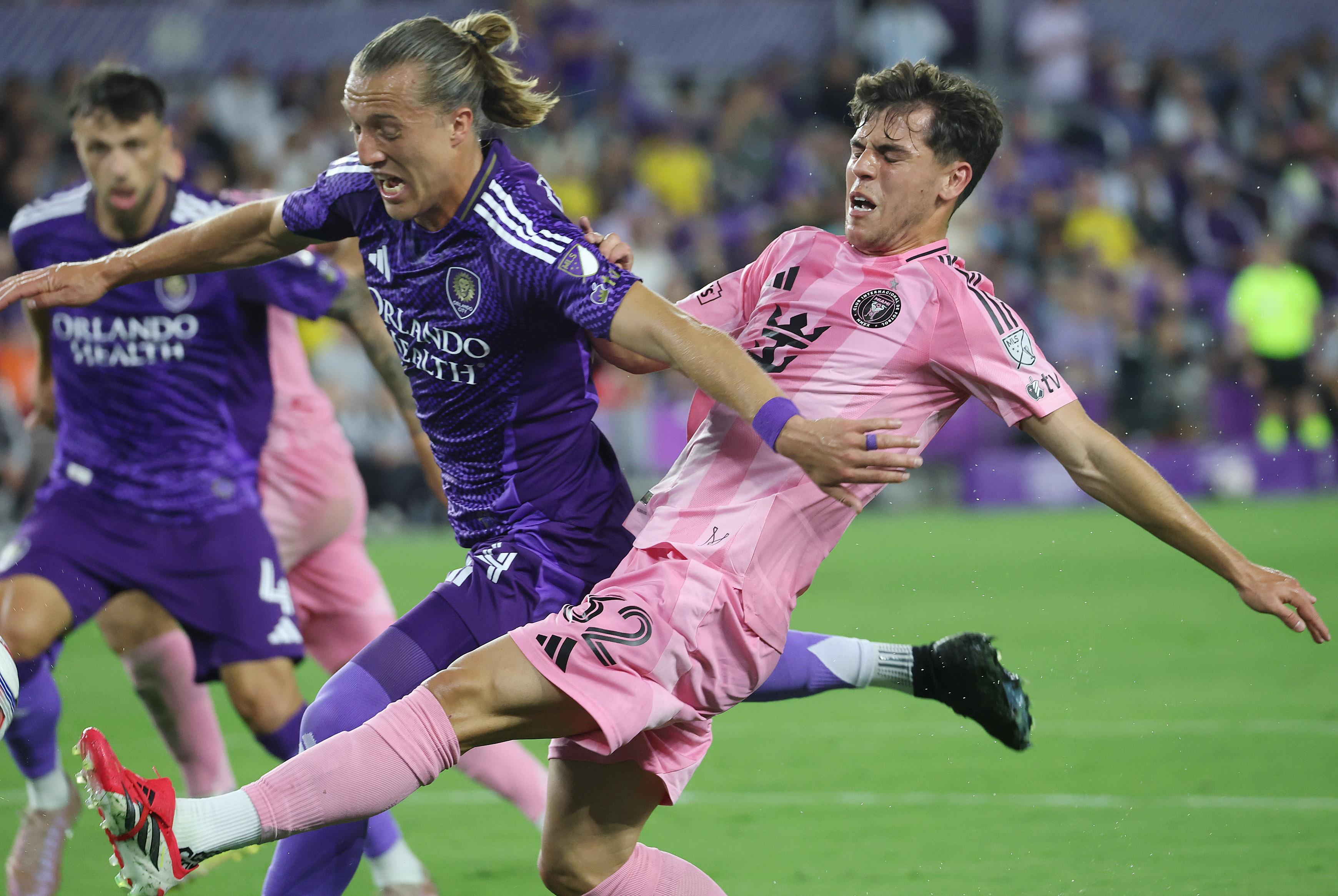 Orlando player Griffin Dorsey (left) collides with Miami player Noah...
