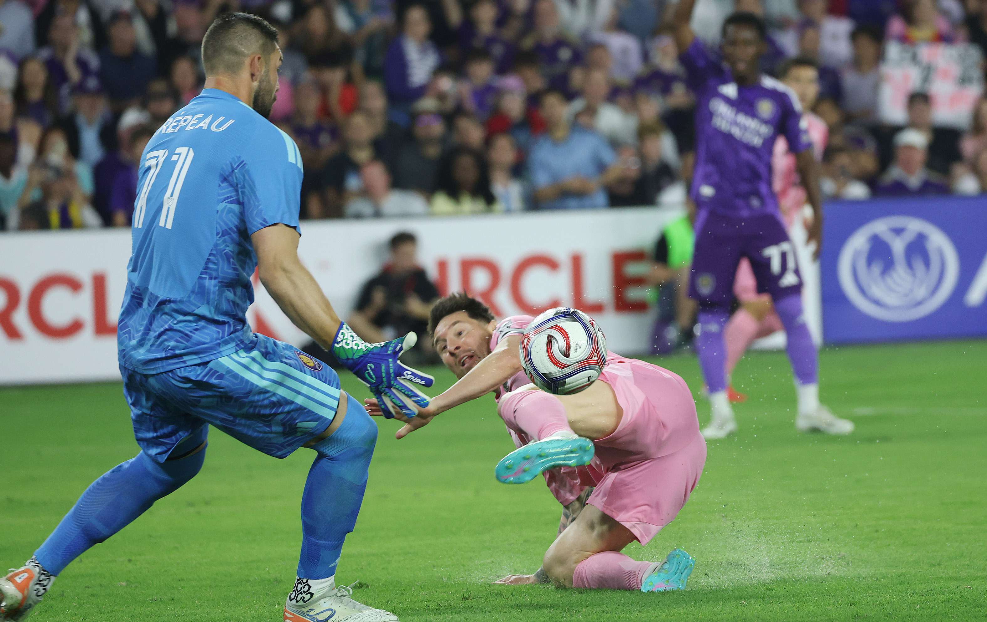 Miami player Lionel Messi (bottom) tries to get the ball...