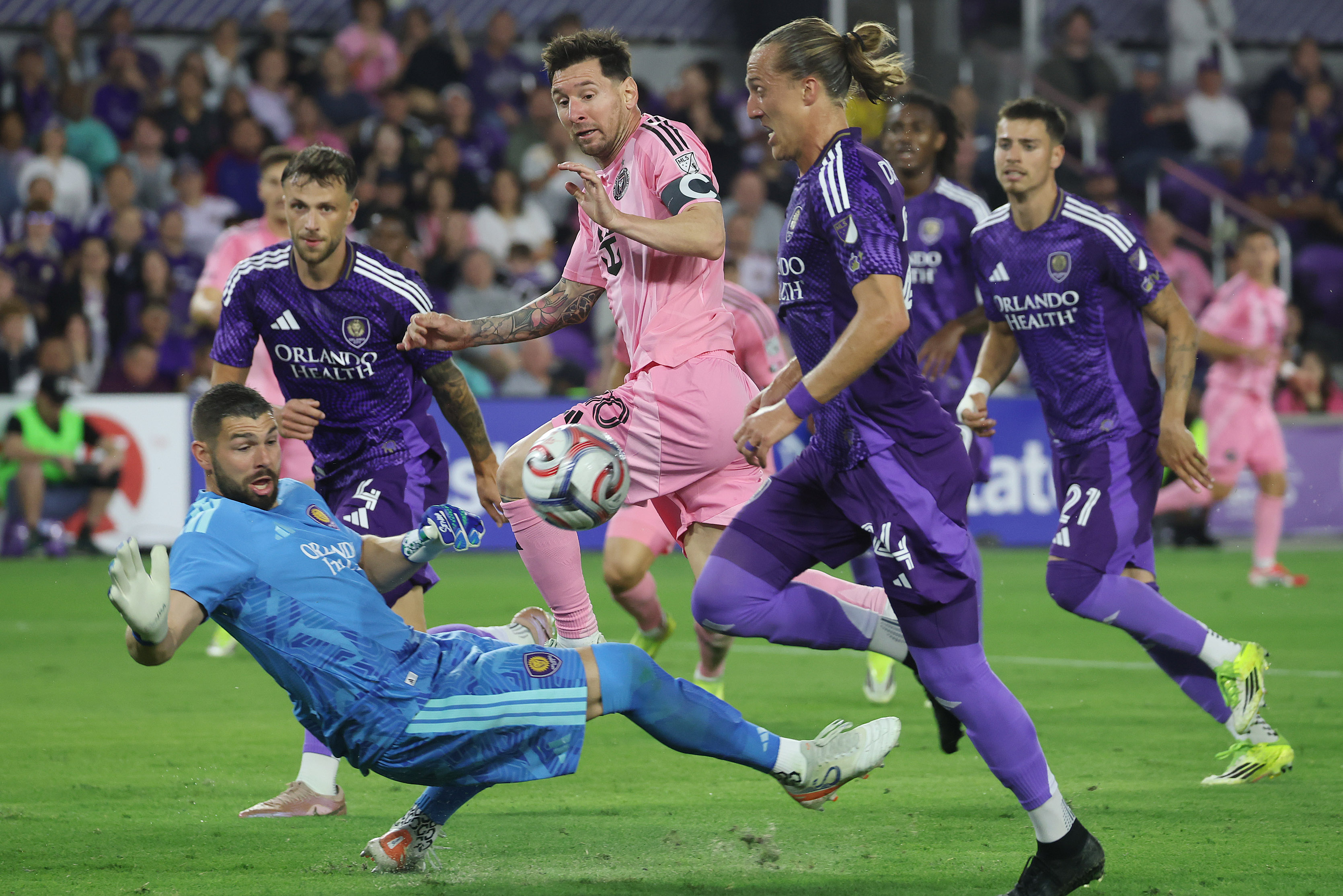 Orlando goalkeeper Maxime Crepeau (bottom left) and Orlando player Griffin...