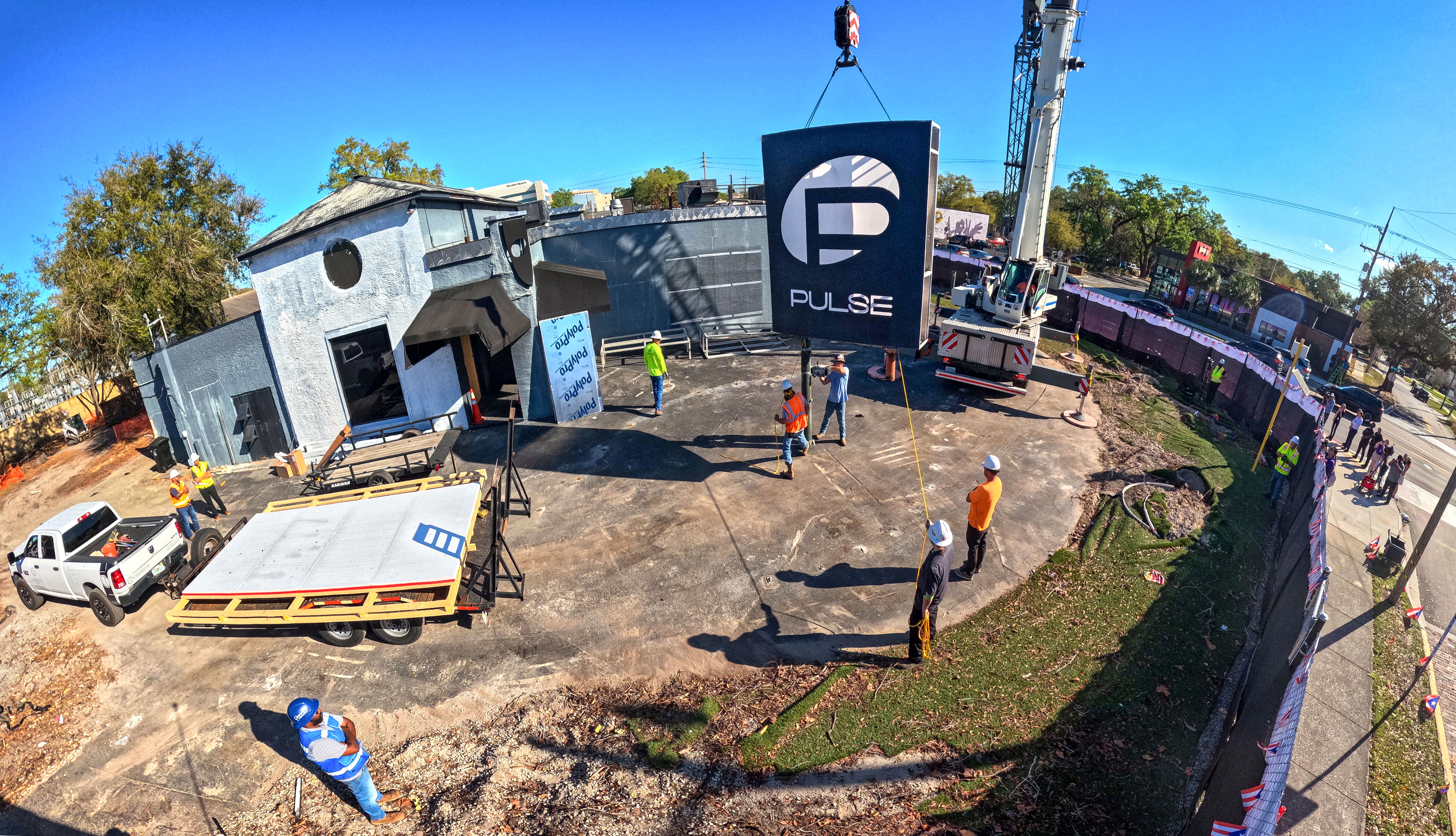 The sign for the Pulse nightclub is removed by workers,...