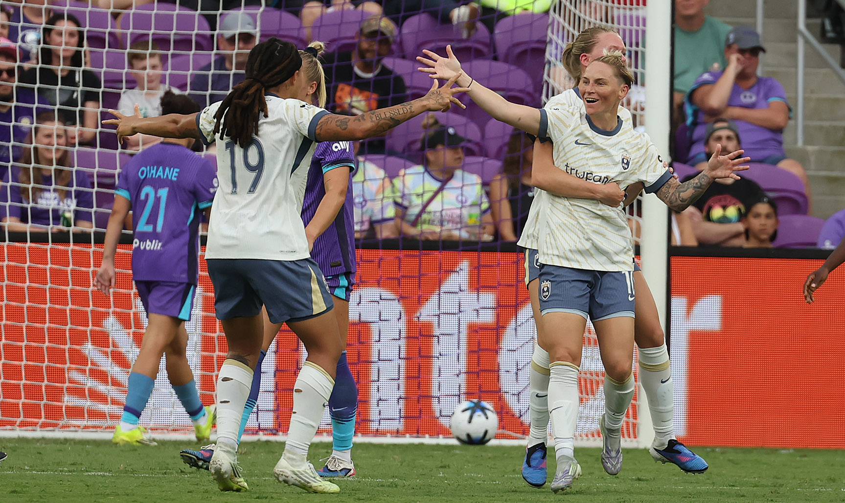 Seattle players Jess Fishlock (10) and Mia Fishel (19) celebrate...