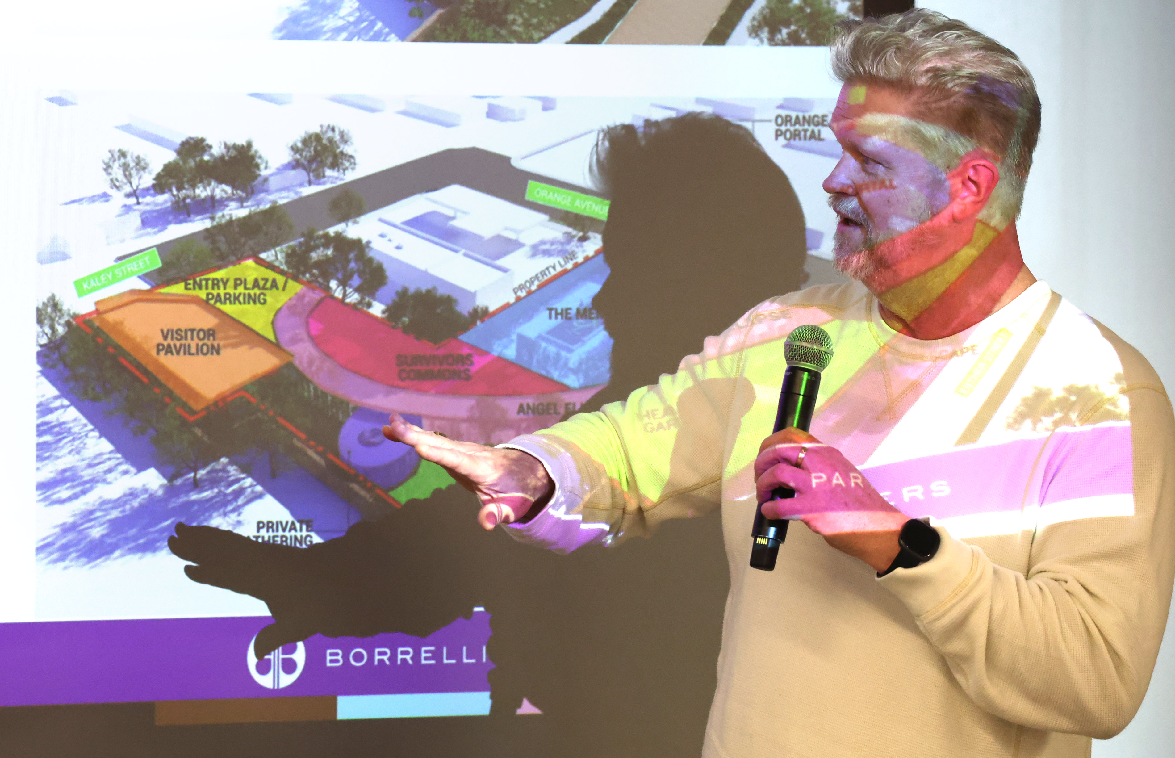 Jay Hood speaks in front of a projected rendering during...