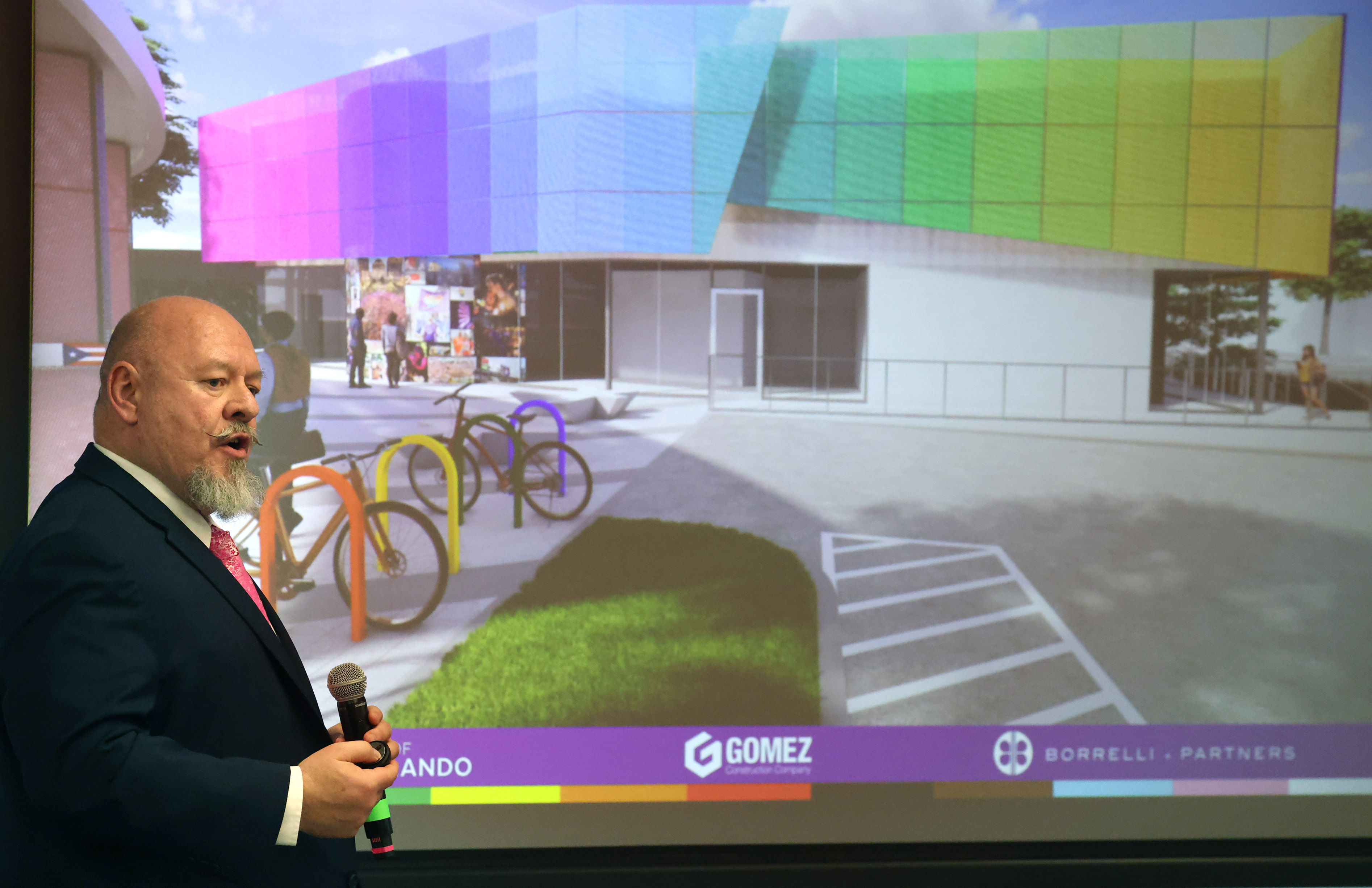 Dan-Michael Trbovich speaks in front of a rendering during a...