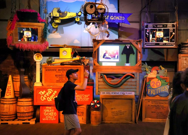 A guest takes photos in the backstage-themed pre-show area of MuppetVision 3D. (Joe Burbank/Orlando Sentinel)