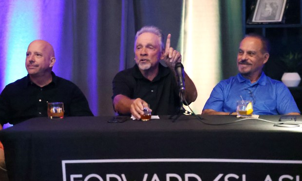 Brian Schmitz (middle) tells a tale between Mike Bianchi (left) and George Diaz (right) during a discussion about sports in Central Florida at Forward/Slash Distillery & Blending House in Winter Park on Wednesday, March 25, 2026. Sentinel columnist Mike Bianchi was joined by former colleagues Brian Schmitz and George Diaz and Orlando sports radio legend Marc Daniels to talk about the evolution of Orlando's pro, college and amateur sports. Jason Siegel, the president and CEO of Greater Orlando Sports Commission, and Steve Hogan, CEO for Florida Citrus Sports, joined the conversation to discuss the area's sports scene and its future. (Stephen M. Dowell/Orlando Sentinel)