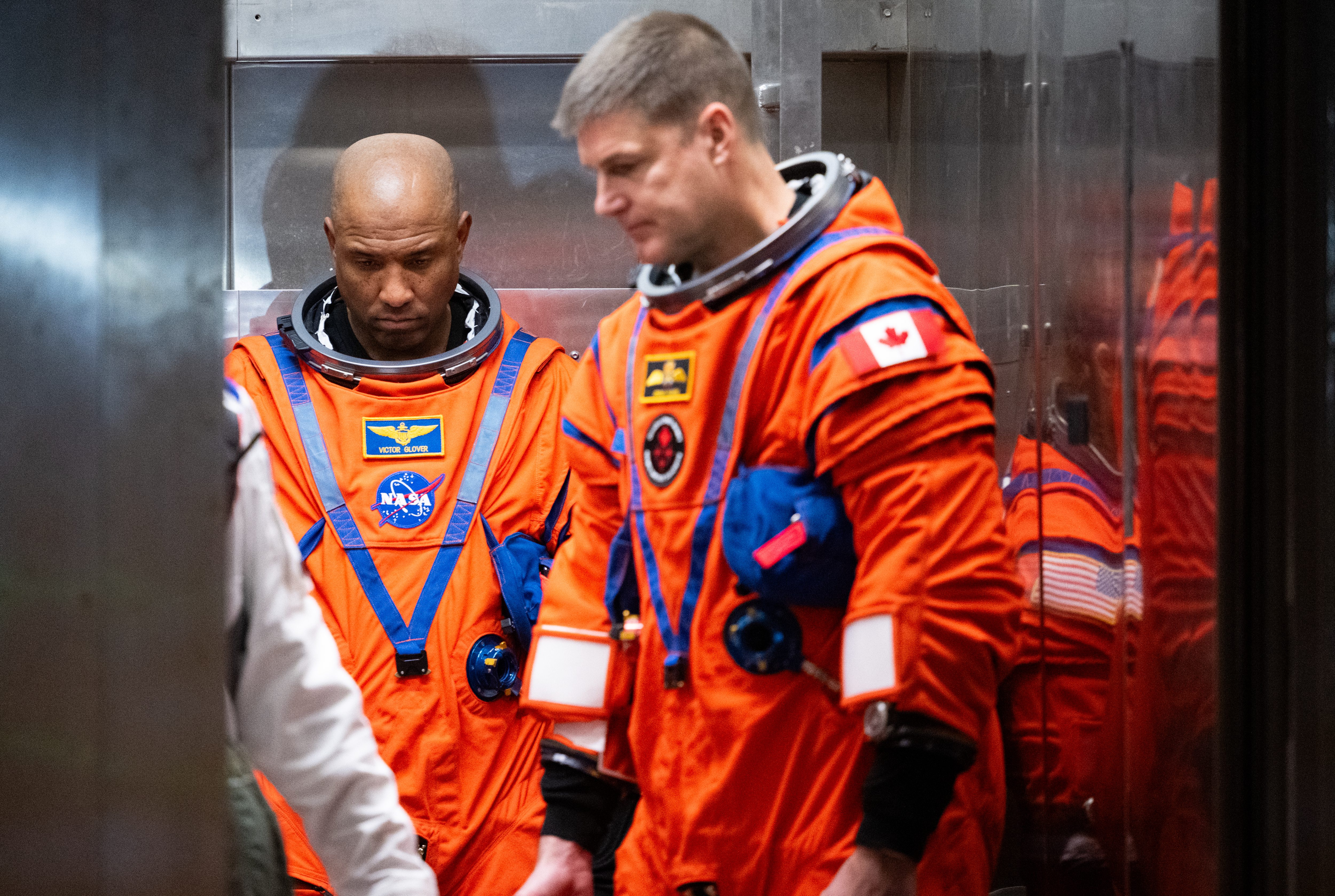 Artemis II crewmember NASA astronaut Victor Glover, pilot; left, and...