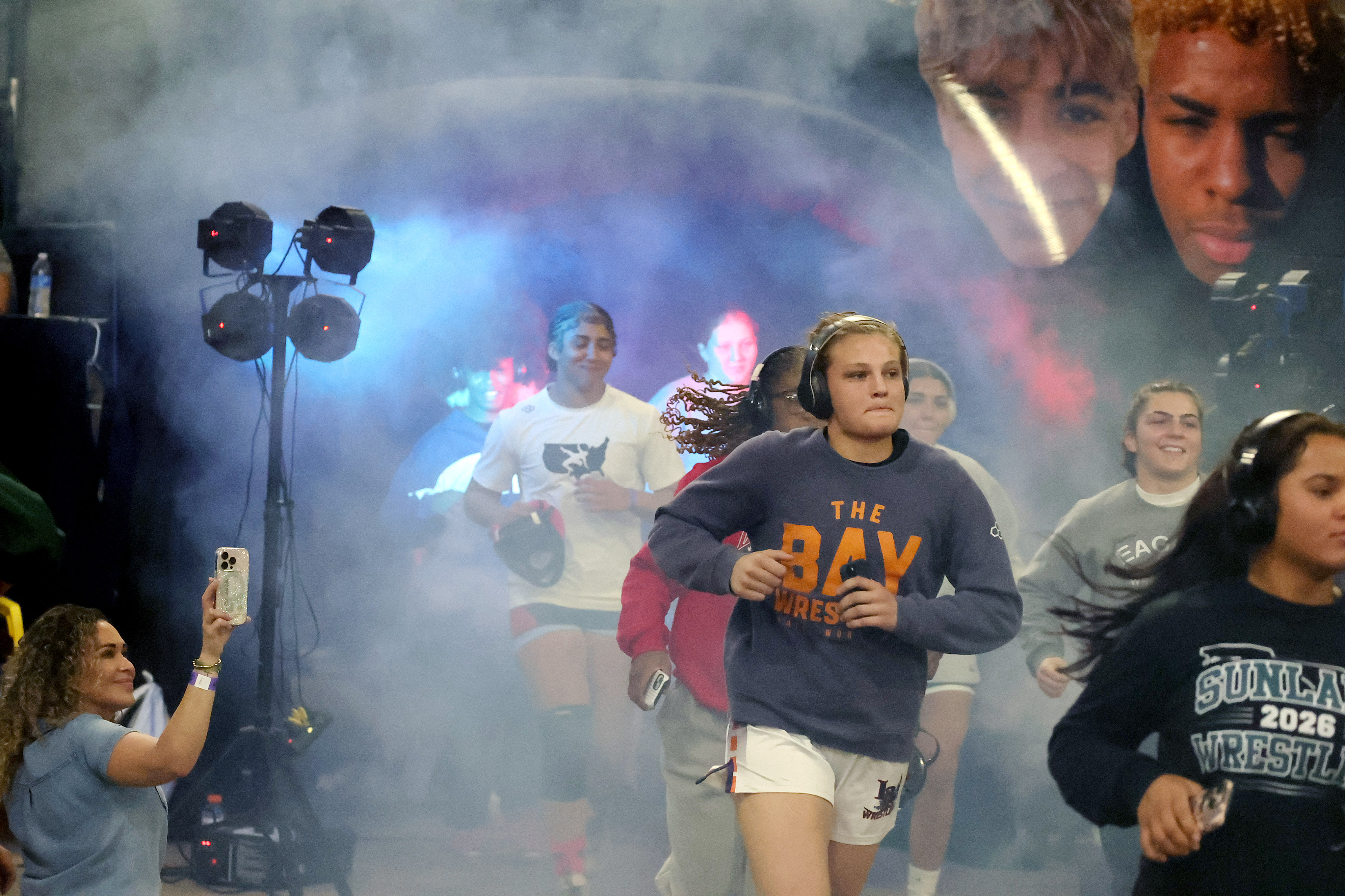 Varsity girls wrestlers enter the arena for the FHSAA Wrestling...