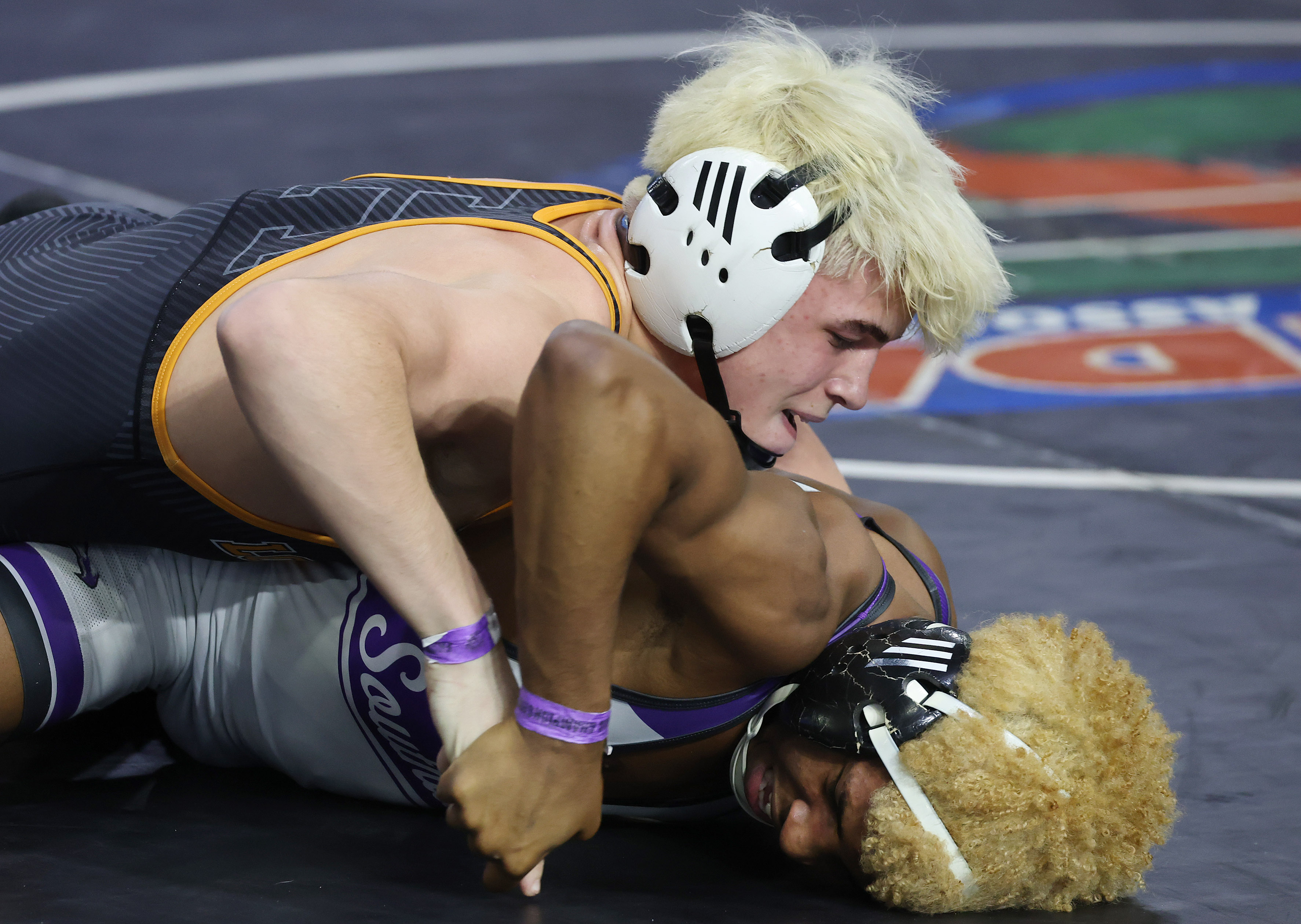 Harmony High's Nathan Lyttle, top, controls Southwest Miami High's Lazaro...