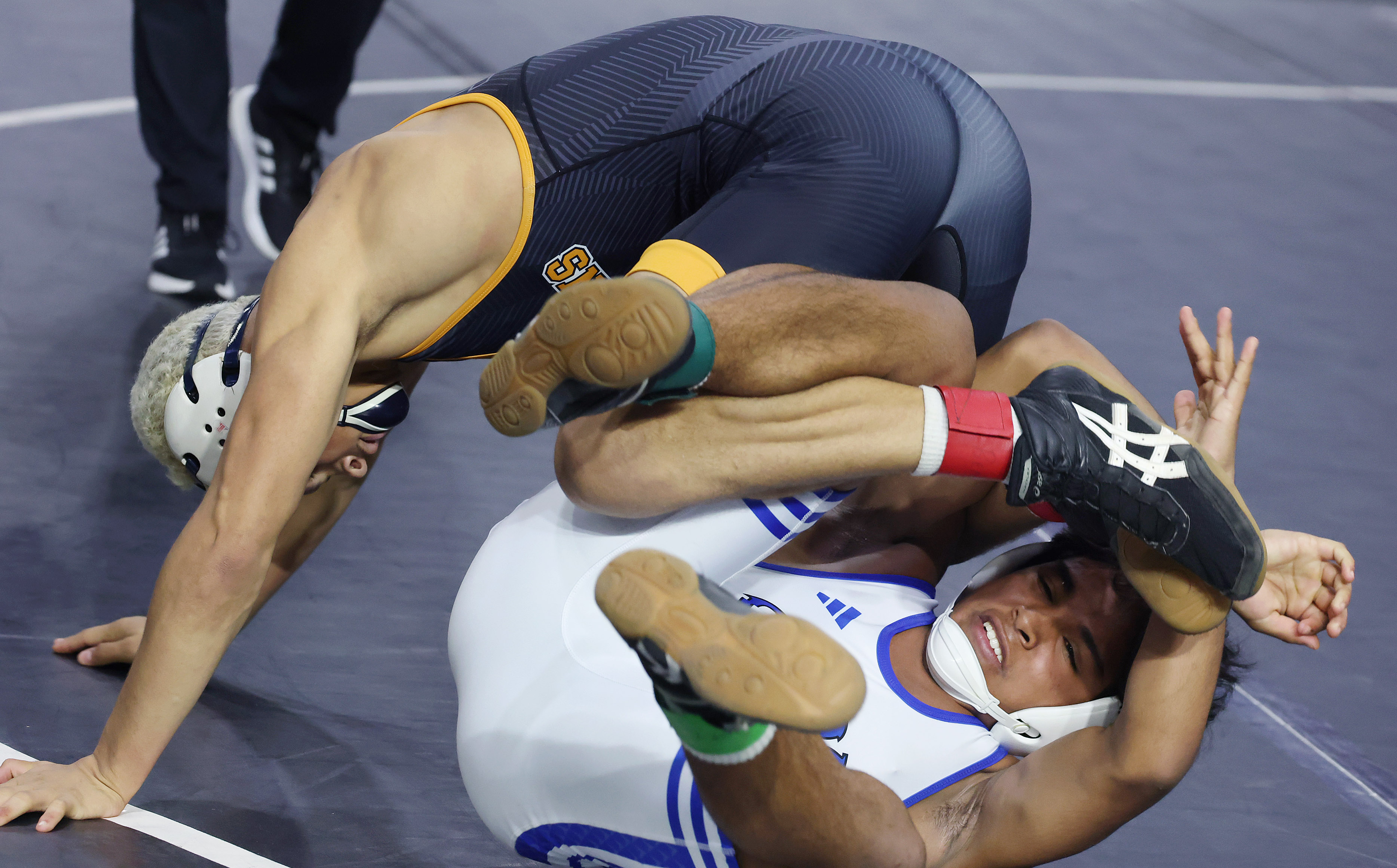 Harmony High's Nathan Barrett, top, controls South Dade's Armand Williams...