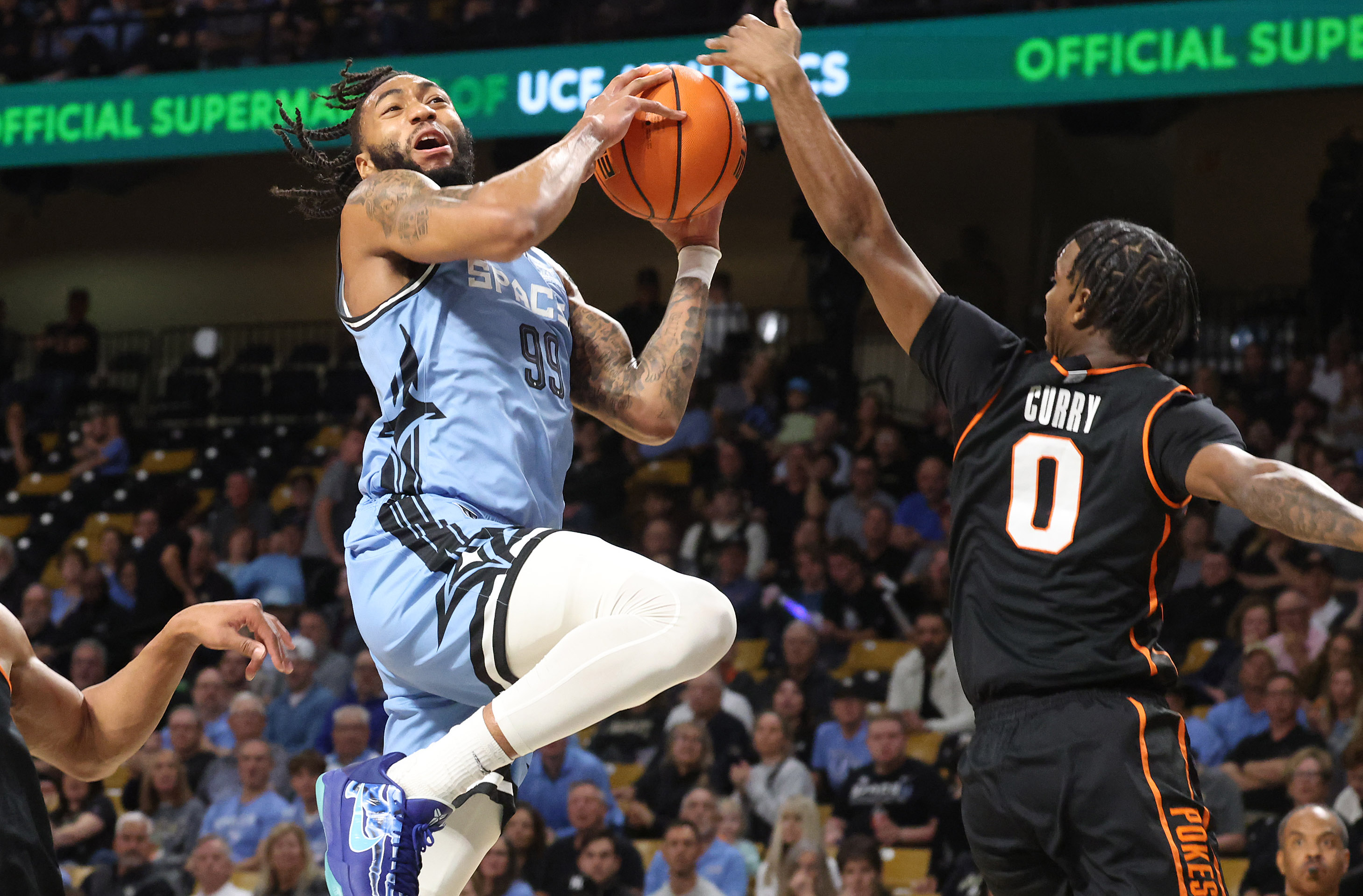 UCF forward Jordan Burks (99) goes up for a shot...