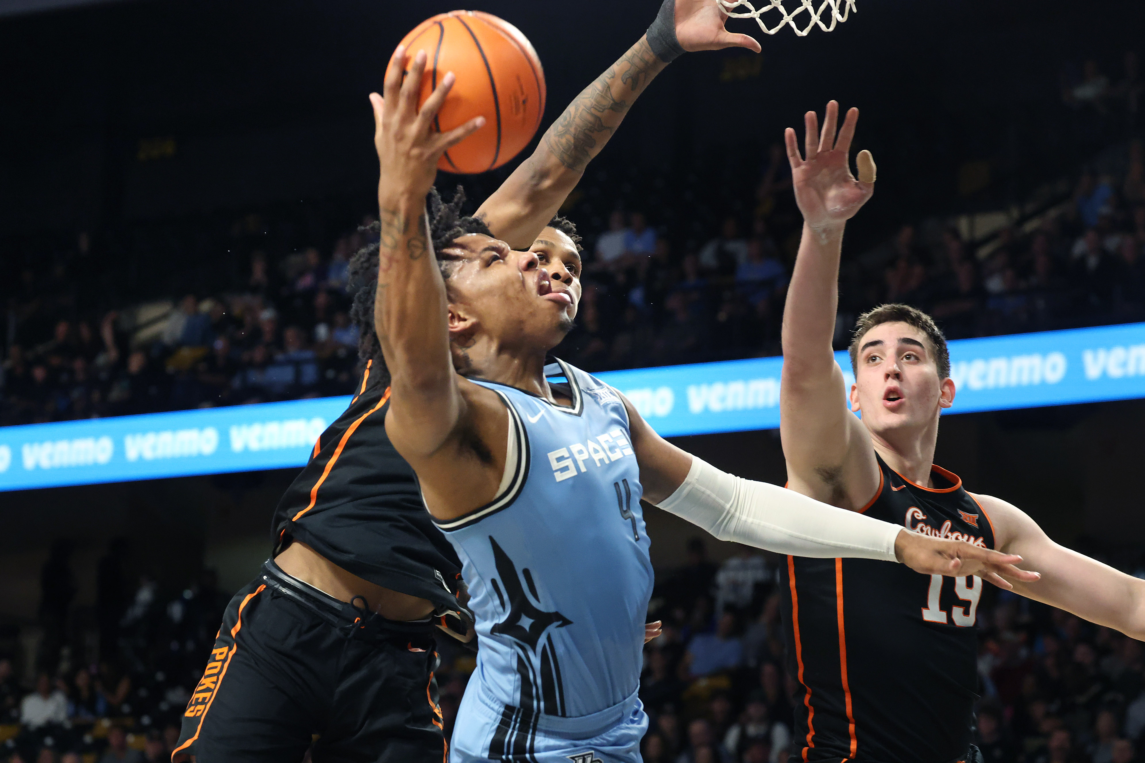 UCF forward Jamichael Stillwell (4) shoots past Oklahoma State forward...