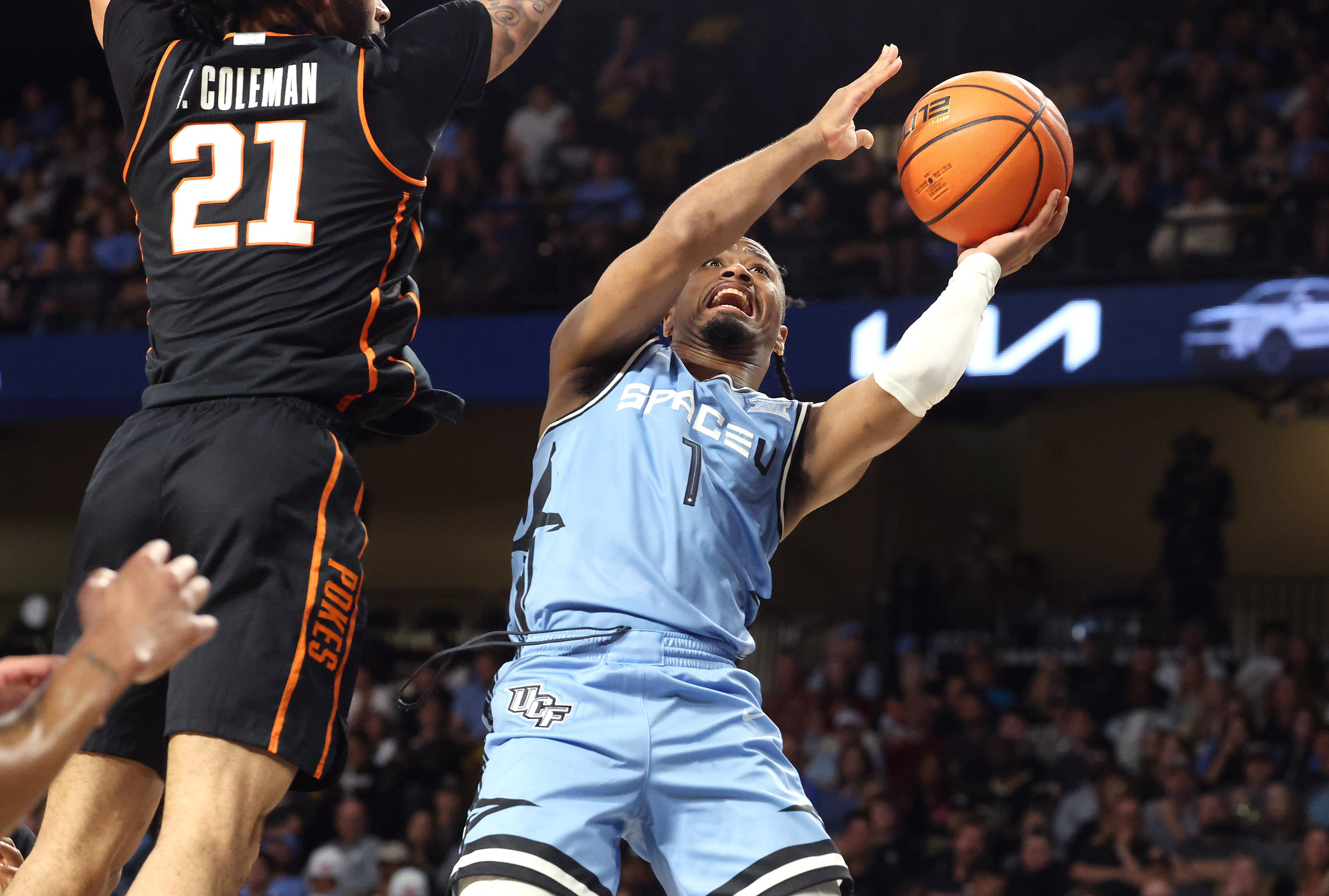 UCF guard Themus Fulks (1) shoots beneath Oklahoma State guard...