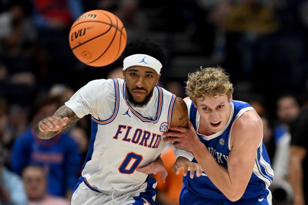 Boogie Fland (0) of the Florida Gators and Collin Chandler (5) of the Kentucky Wildcats battle for the ball during the Gators' victory in the SEC tournament quarterfinals Friday at Bridgestone Arena in Nashville, Tennessee. (Carly Mackler/Getty Images)