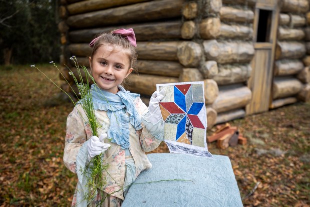 Emery Webb, 5, shows children's crafts in period dress in the historic town of Ethel at Rock Springs Run State Reserve in Sorrento on March 12, 2026 (Patrick Connolly/Orlando Sentinel)