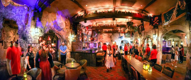 Guests preview The Beak and Barrel Tavern, Friday, Aug. 22, 2025, at the Magic Kingdom in Walt Disney World. Opening Aug. 29, the Pirates of the Caribbean-themed venue features the park's first dedicated bar for cocktails, beer and wine. (Joe Burbank/Orlando Sentinel)